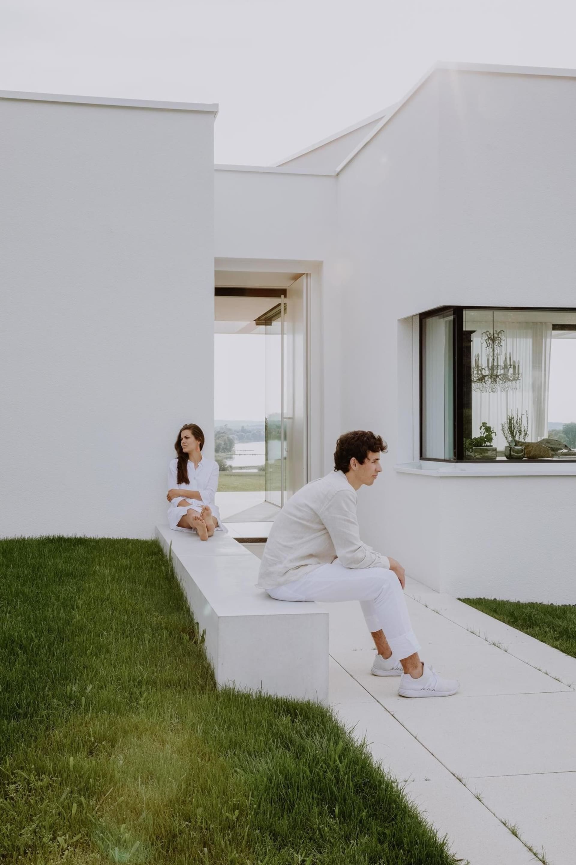 A modern white house with a grassy landscape