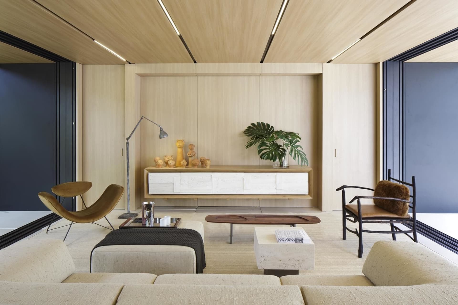 Modern living room featuring wooden furniture, minimalist design, and natural light.