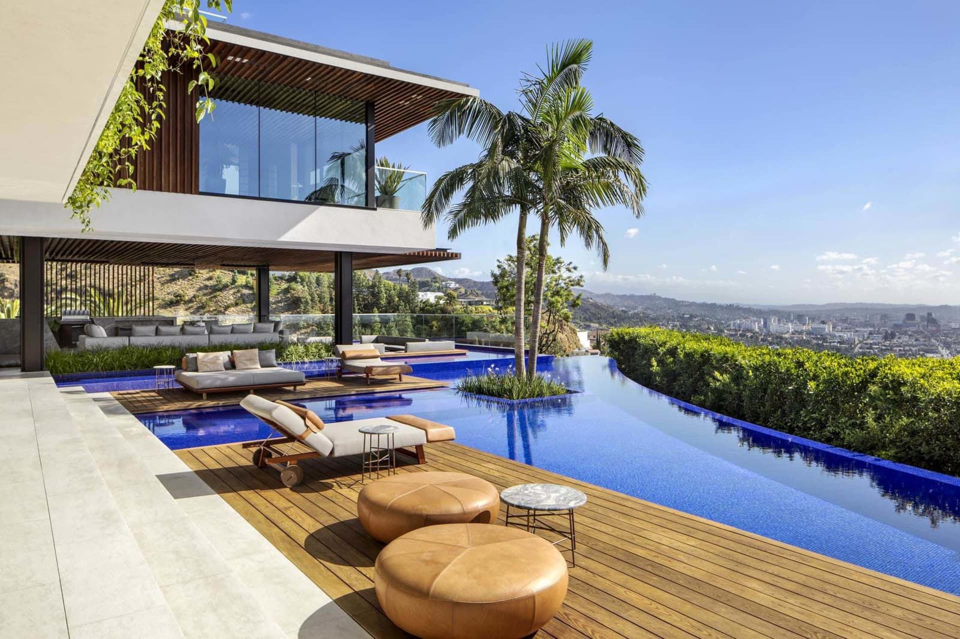 Modern residential architecture with a swimming pool and outdoor seating area.