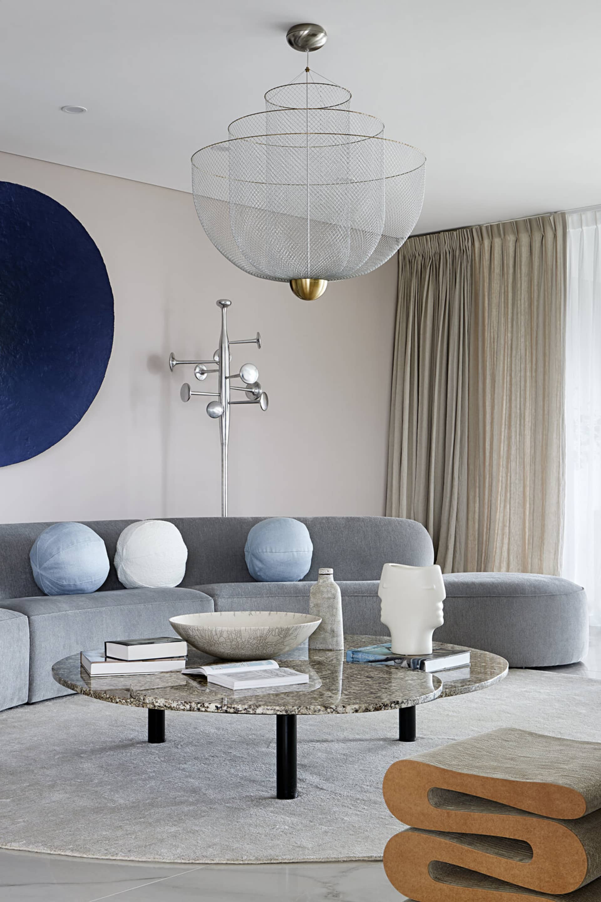 Contemporary living room featuring concrete and glass materials and a modern design.