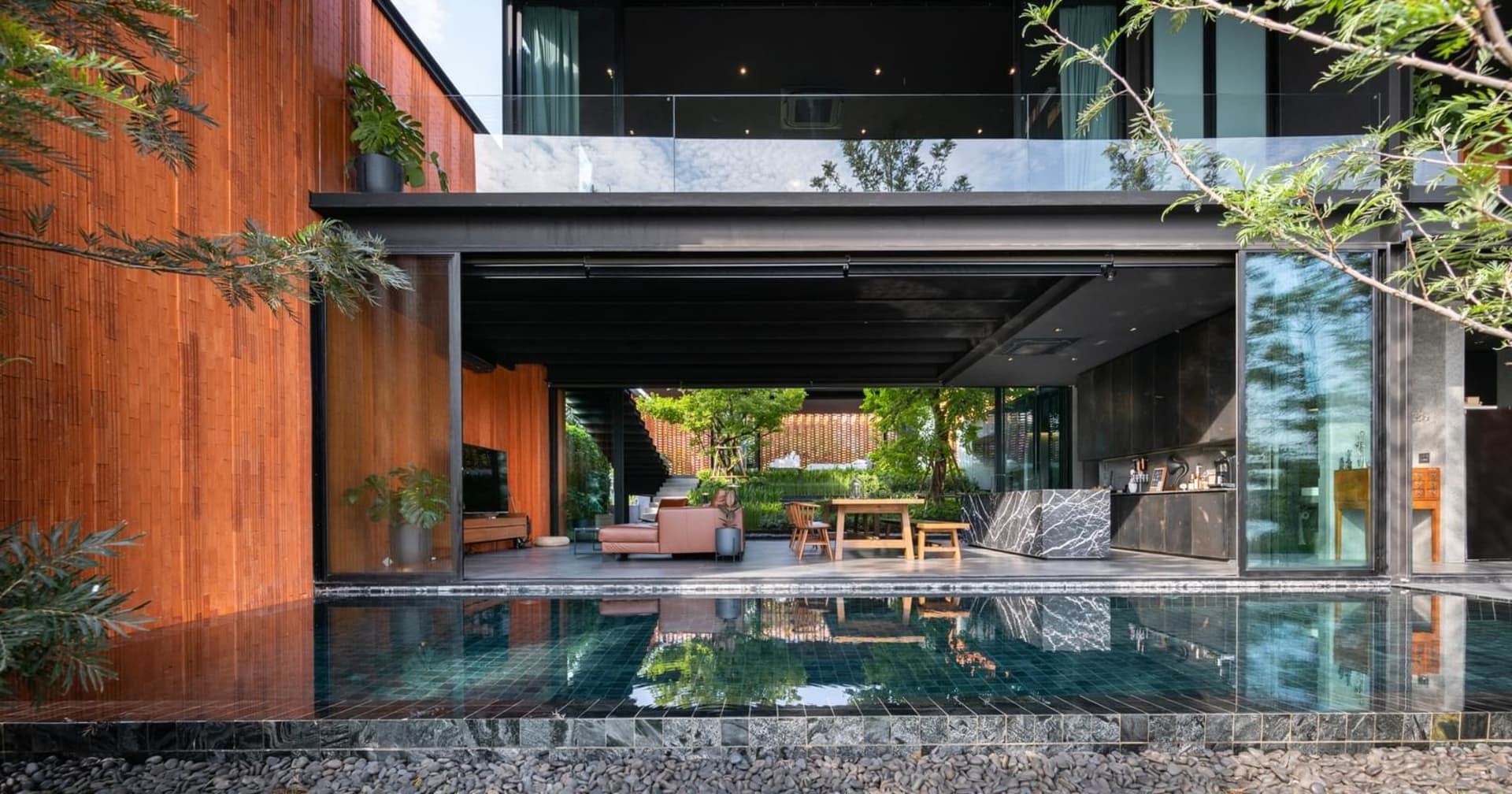 Modern residential living room featuring wood, glass, and marble materials.