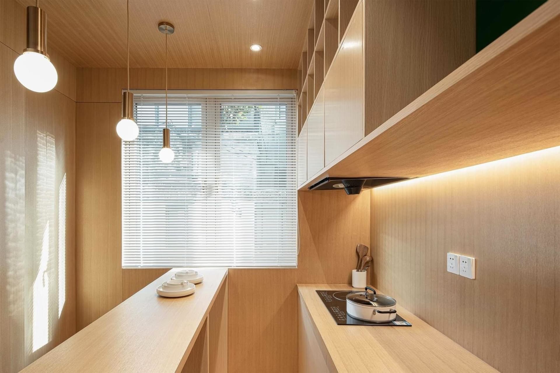 A modern kitchen with wooden panels and stainless steel appliances.