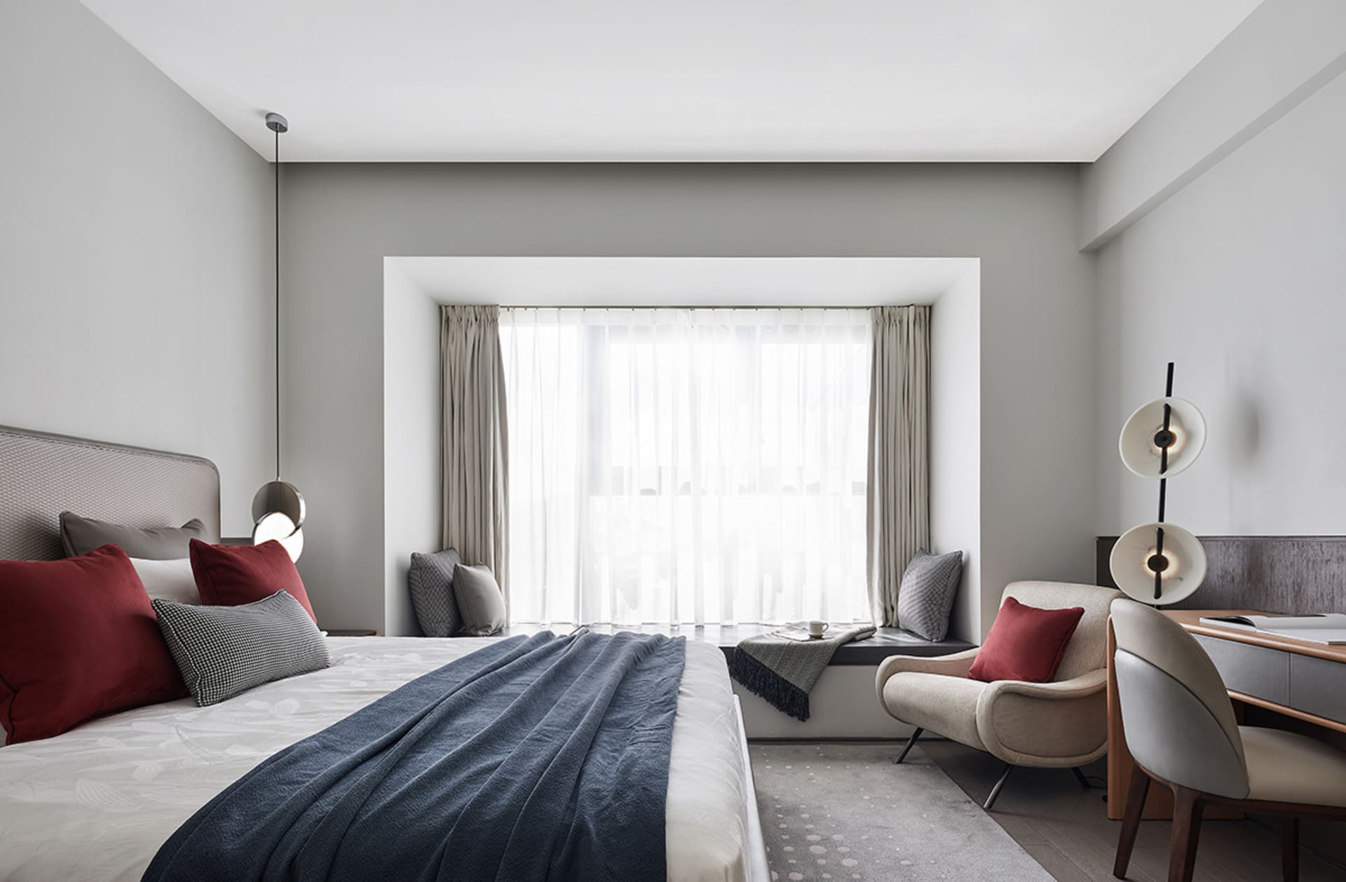 A minimalist bedroom featuring fabric, wood, and metal elements.