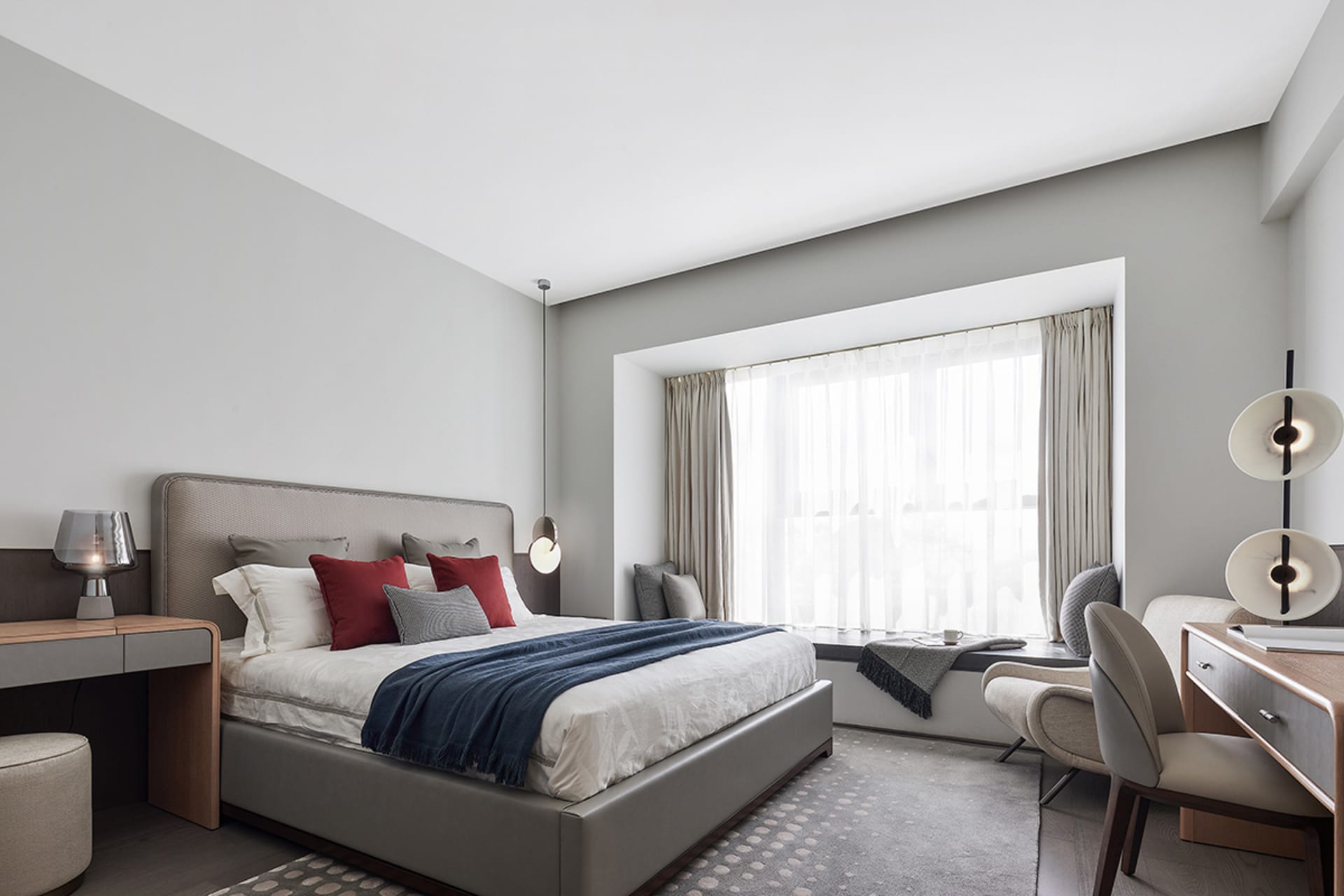 A modern bedroom featuring contemporary furniture and minimalist decor.