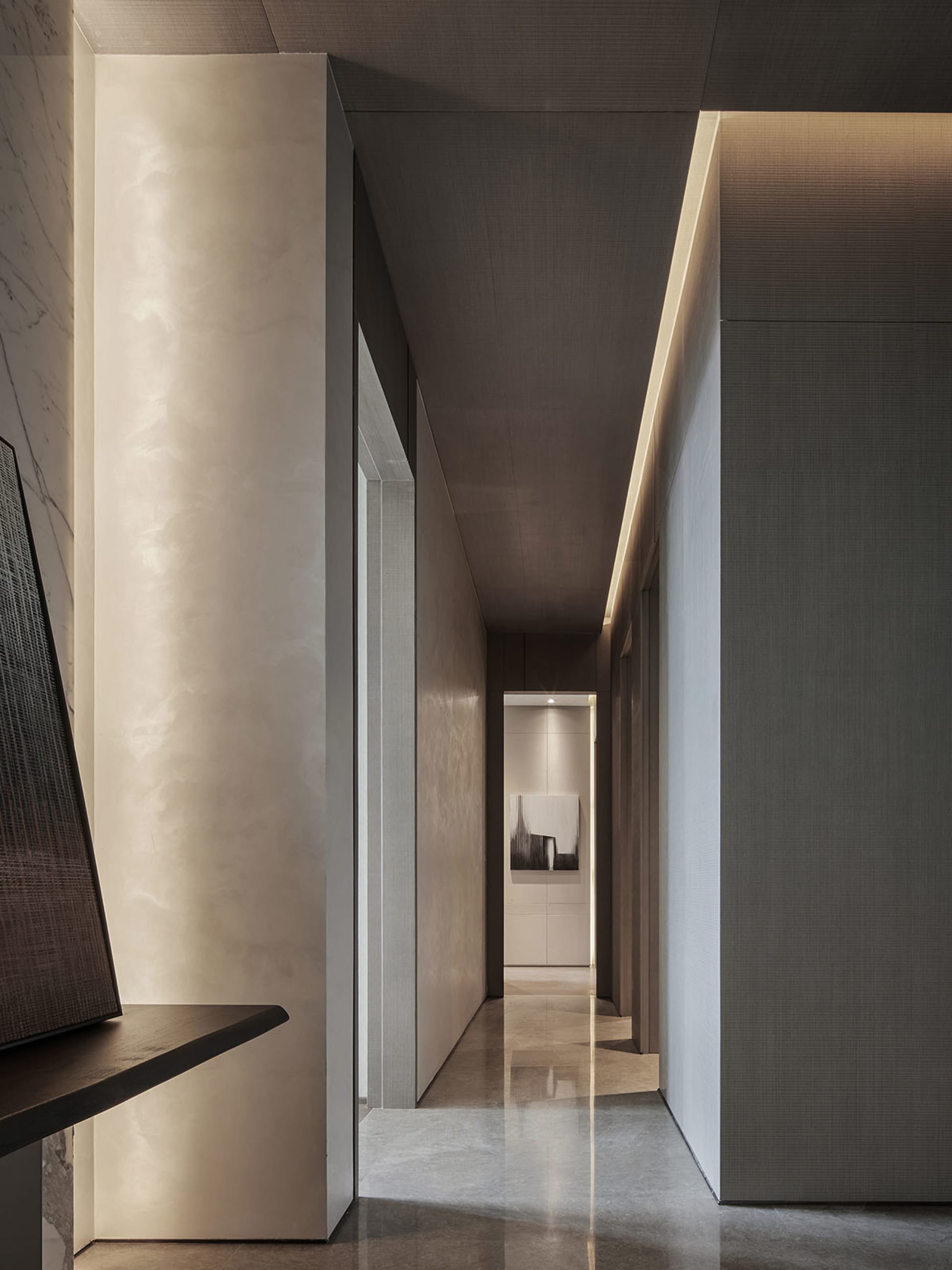 Minimalist corridor featuring polished concrete flooring and walls with industrial lighting.