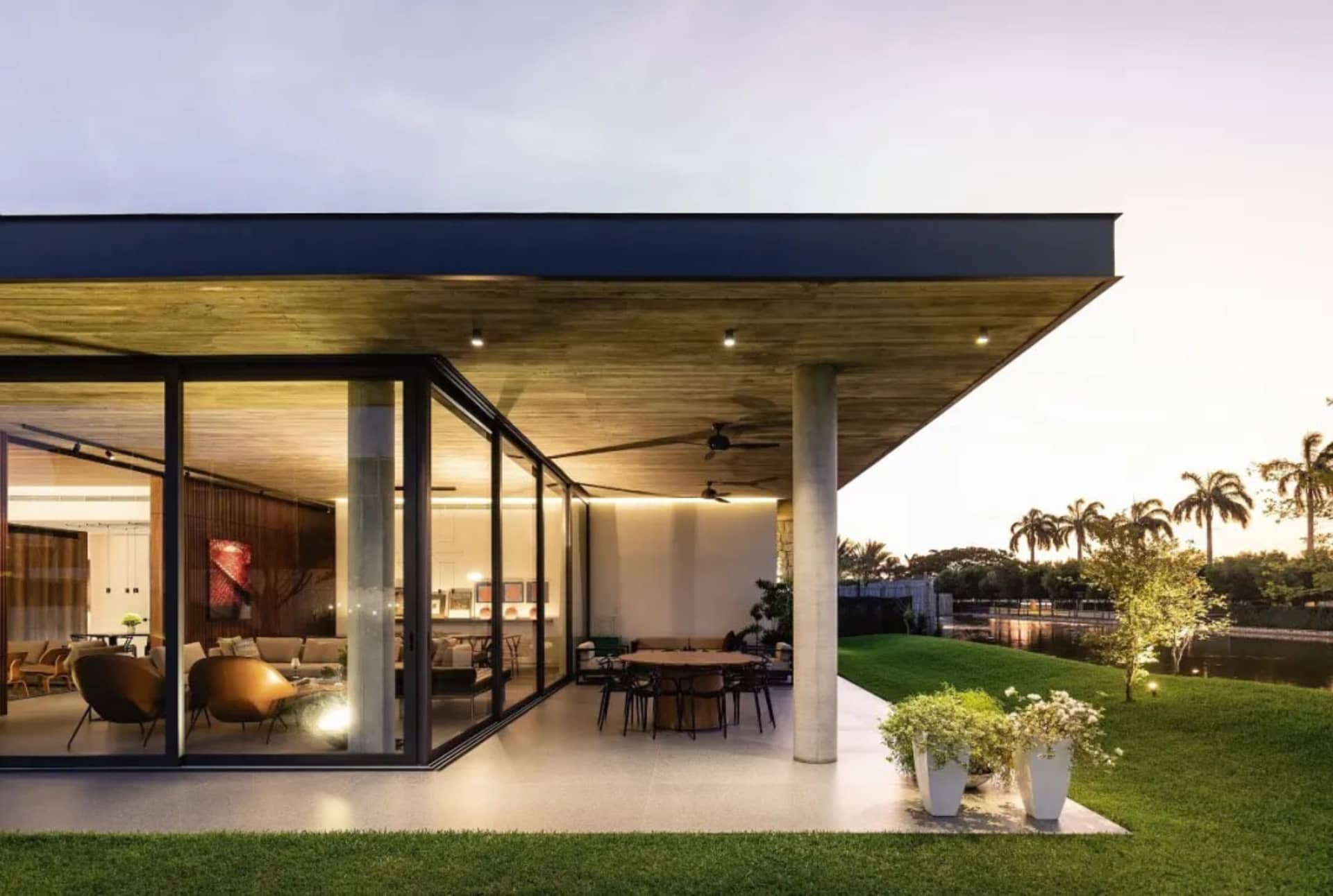 Modern residential design featuring concrete, glass, and wood materials.