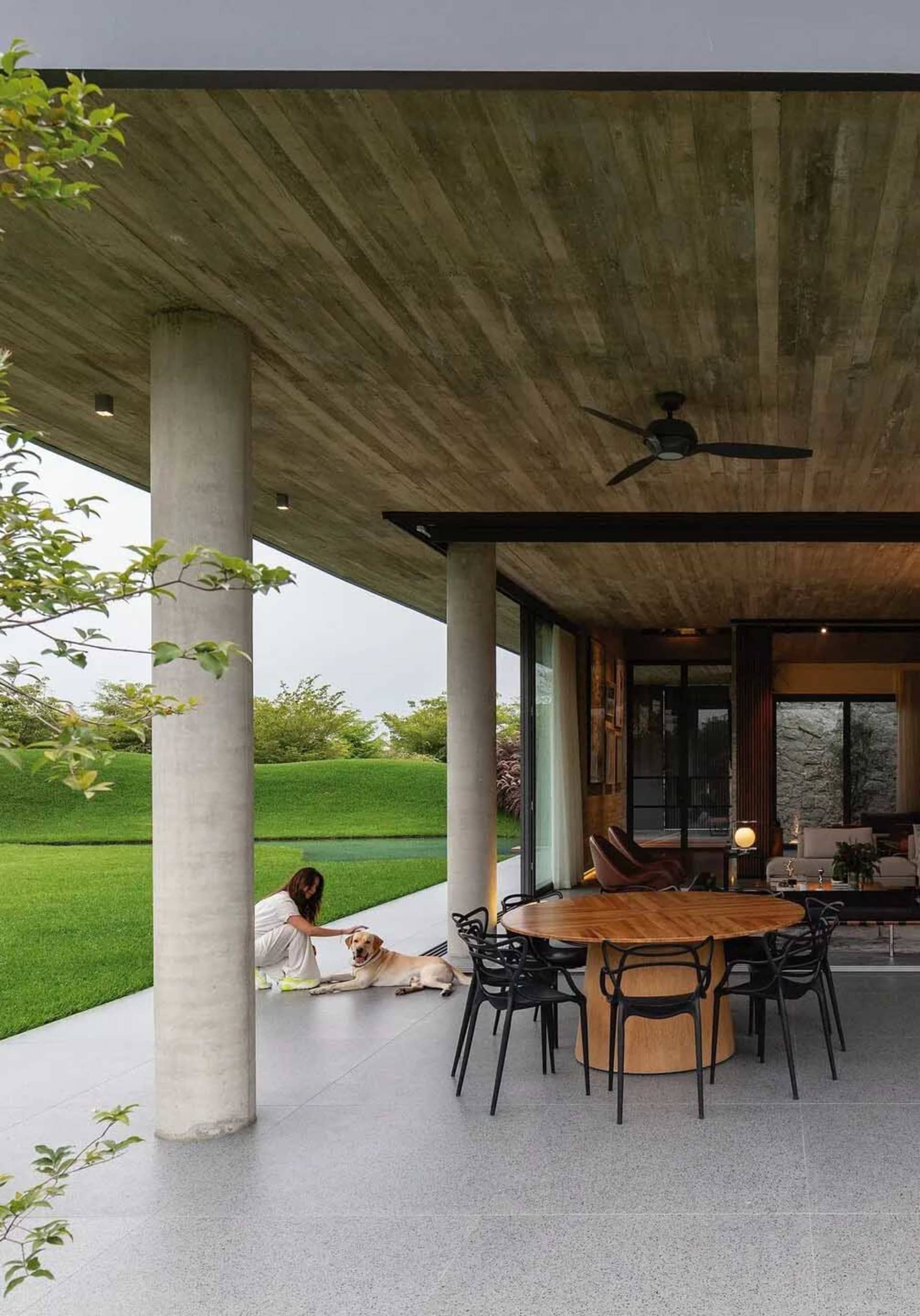 A modern residential exterior featuring concrete and glass materials.