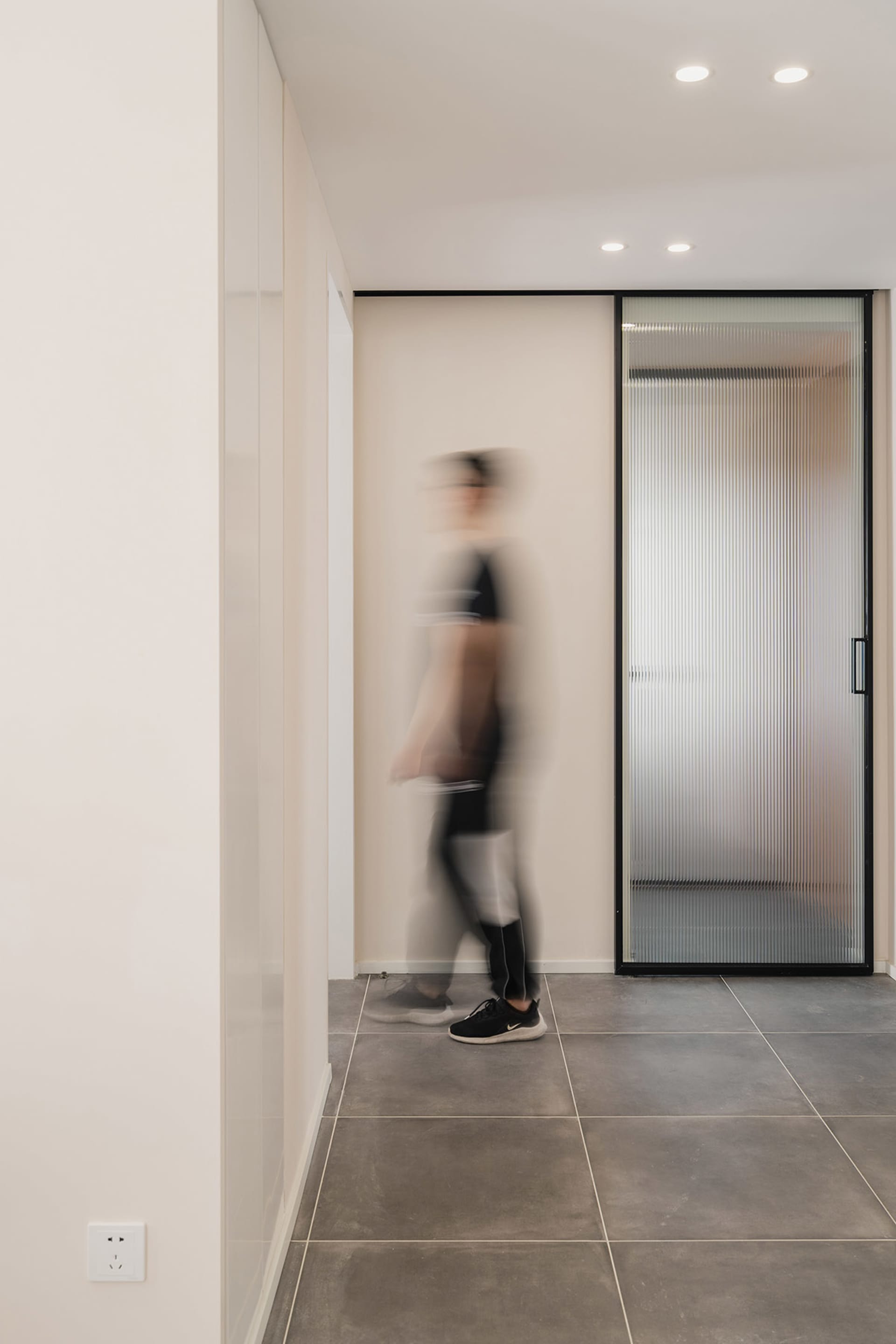 A frosted glass door is installed within a modern, minimalist home decor setting.