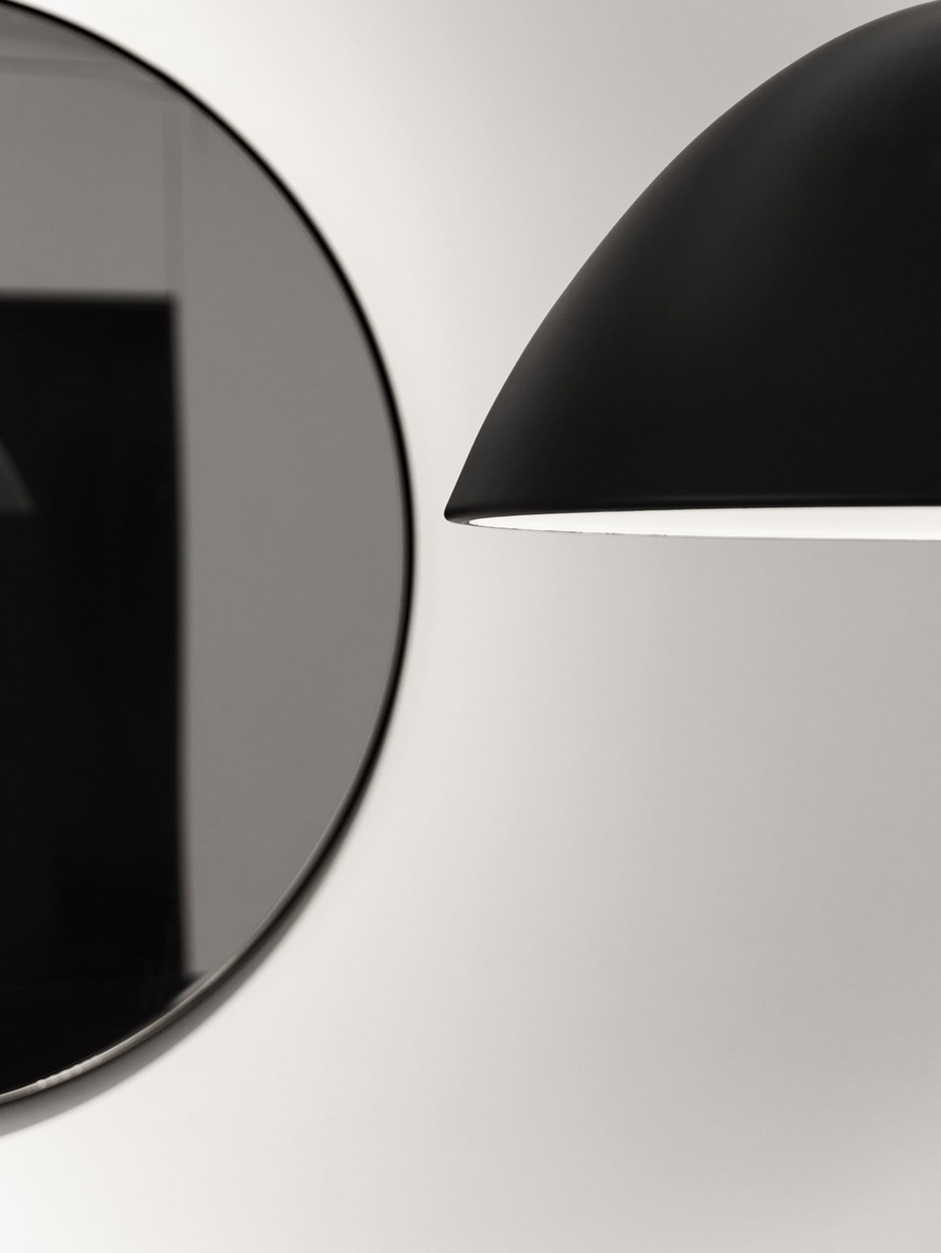 A modern light fixture with a black aluminum shade