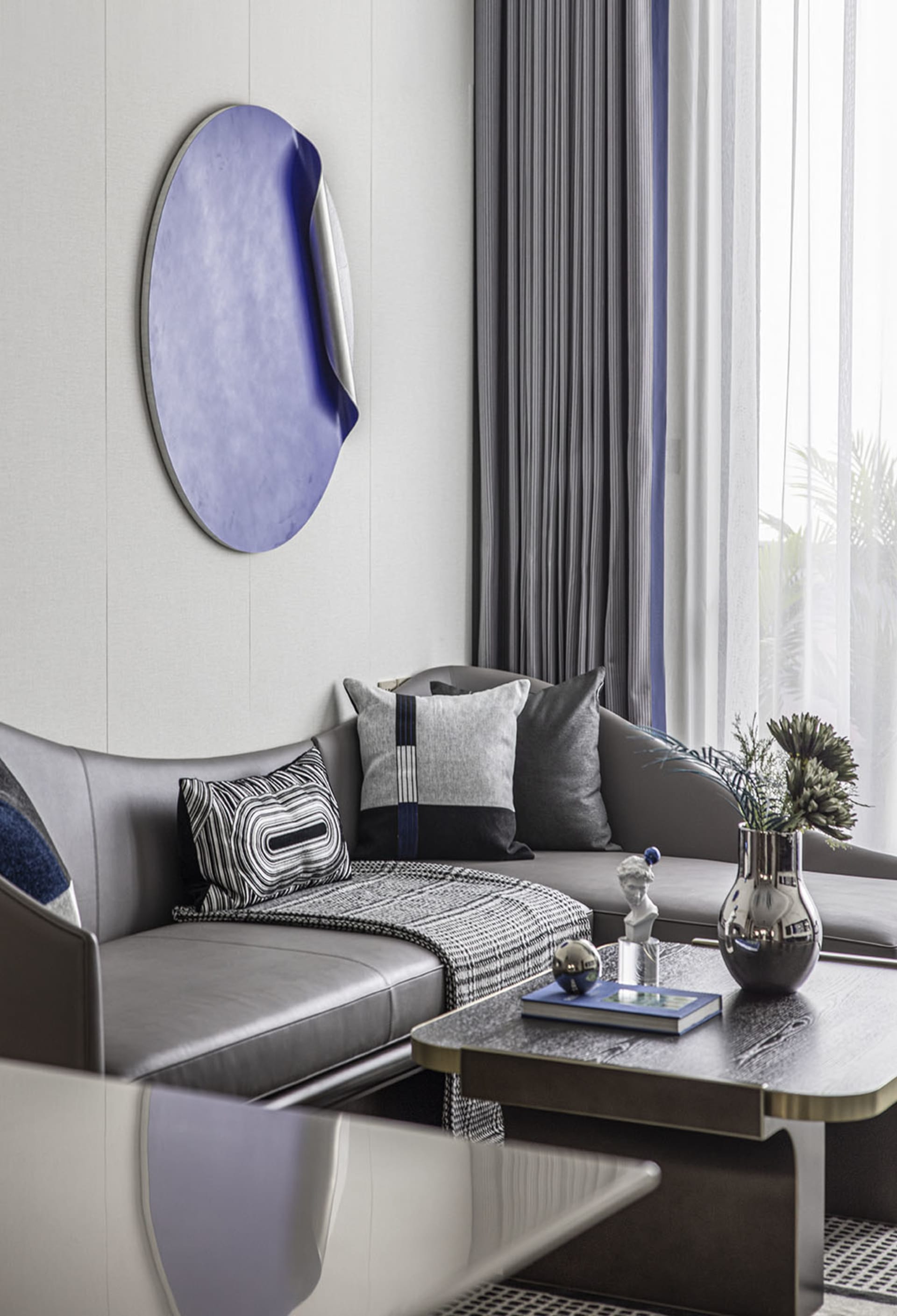Modern living room featuring a stylish leather sofa, patterned throw pillows, and a minimalist coffee table.