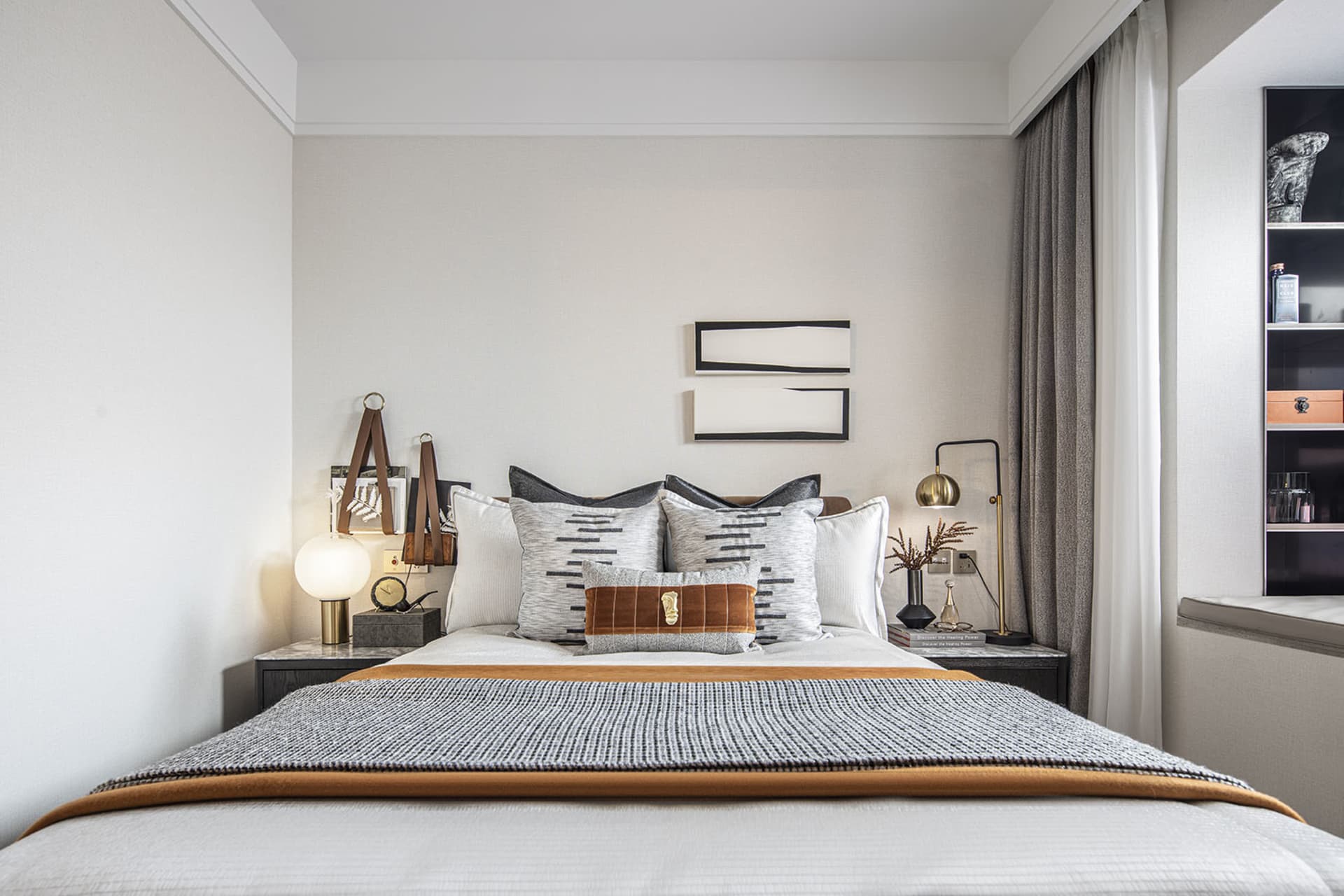 Modern minimalist bedroom with a bed, nightstands, and decorative elements.