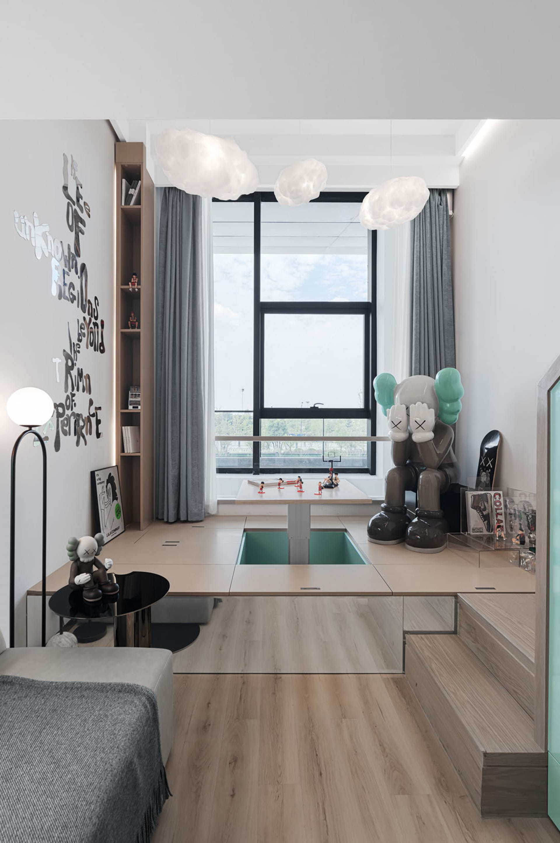 A modern, minimalist children's room with wooden furniture, a window, and decorative elements such as a large statue and book