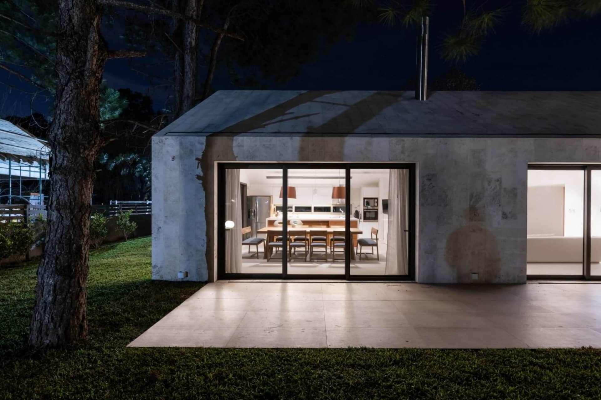 Modern residential building with concrete exterior at night