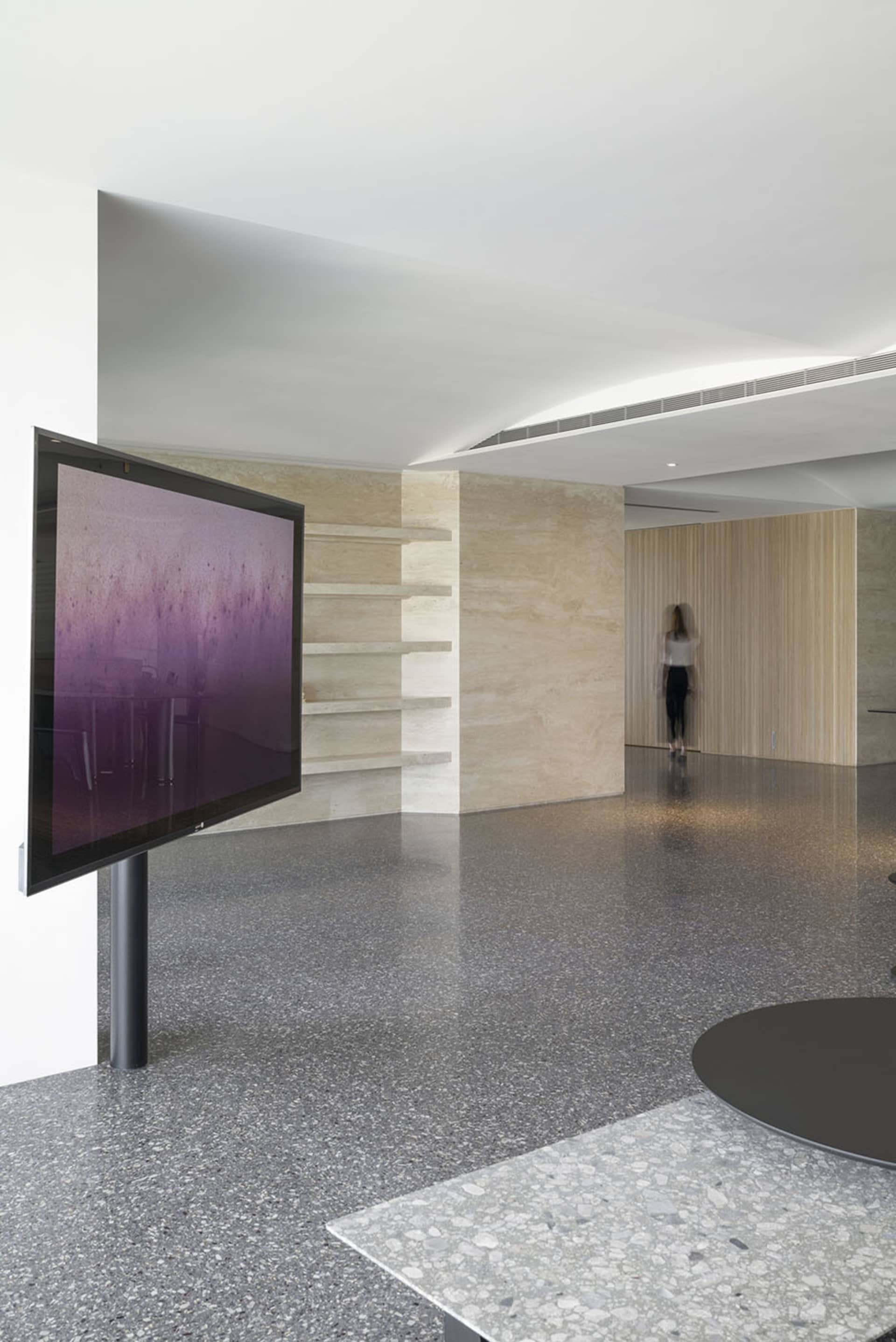 Modern lobby with a terrazzo floor, minimalist design, and contemporary decor.