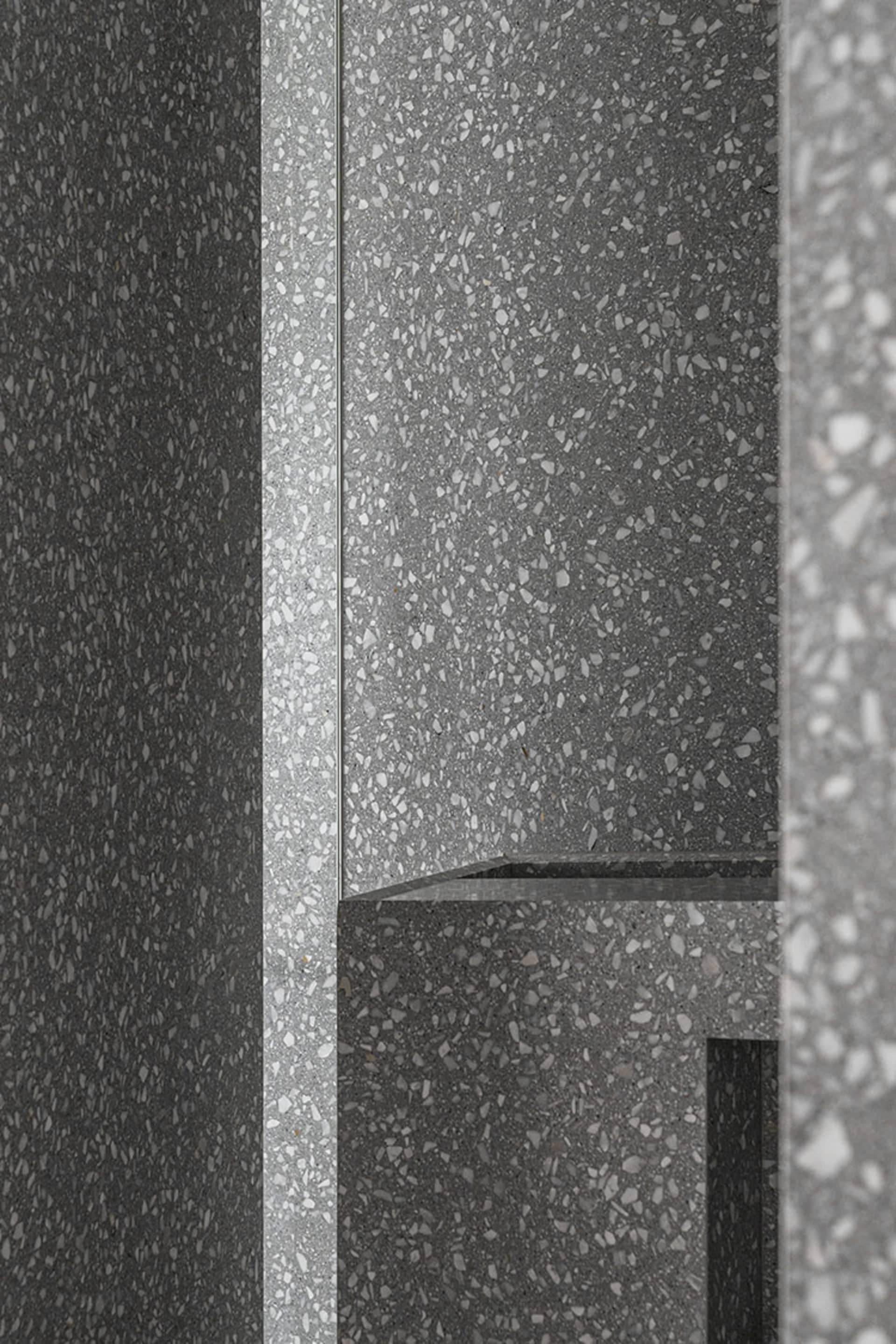 Modern interior design featuring concrete terrazzo flooring and walls.