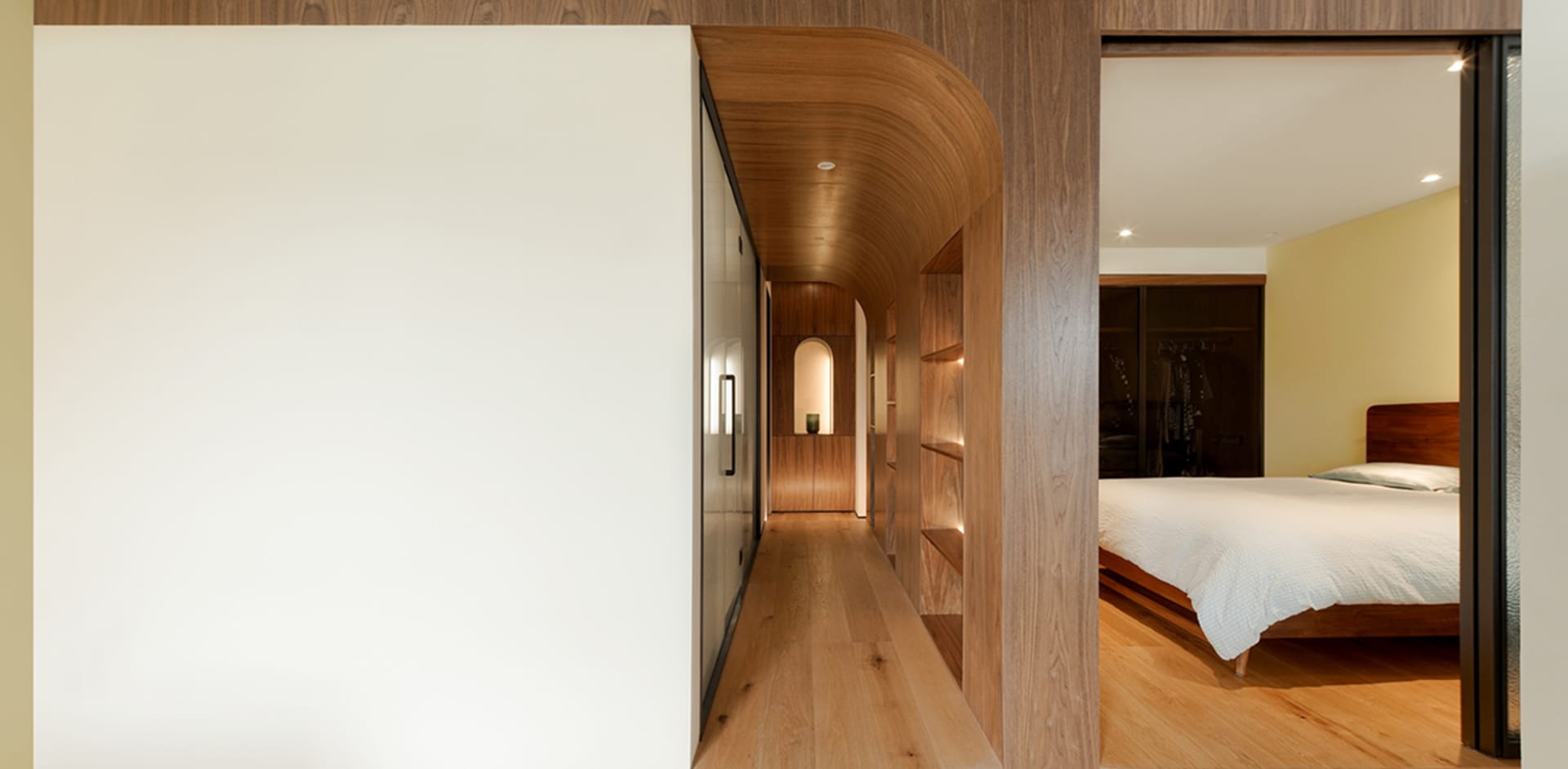 Modern minimalist bedroom featuring a wood cabinet and a cozy ambiance