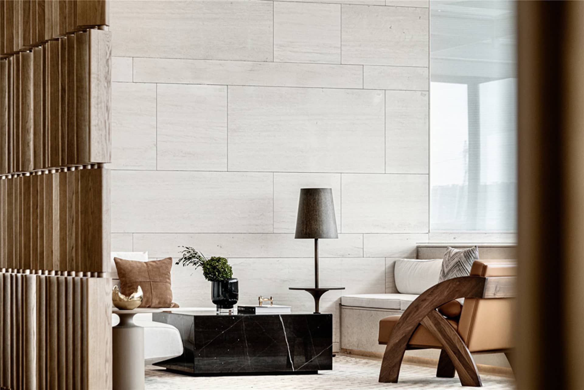 A modern living room with white concrete walls, a black marble coffee table, and a wooden armchair.