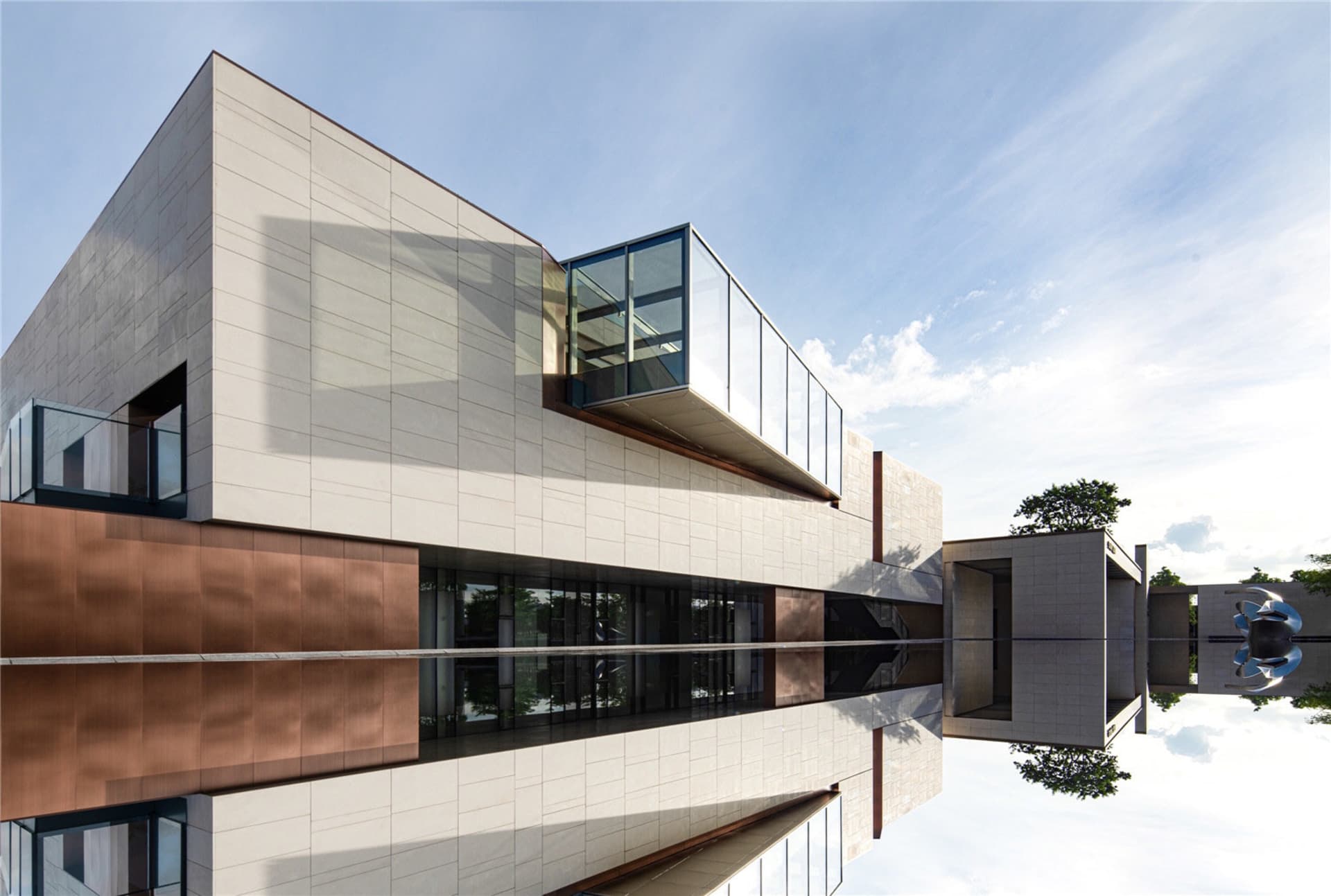 Modern building with concrete and glass exterior under a blue sky