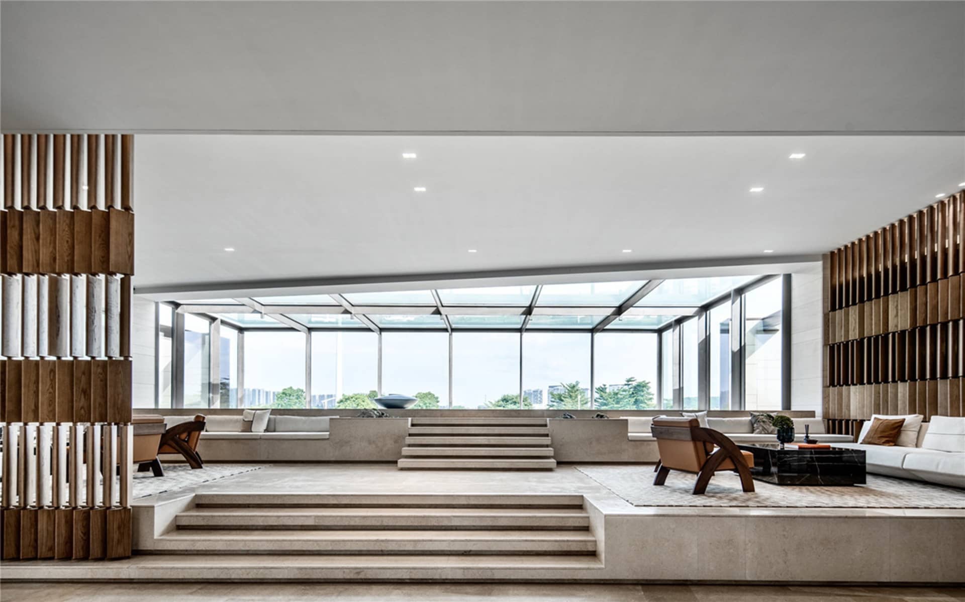 Modern living room with concrete flooring and minimalist furniture.