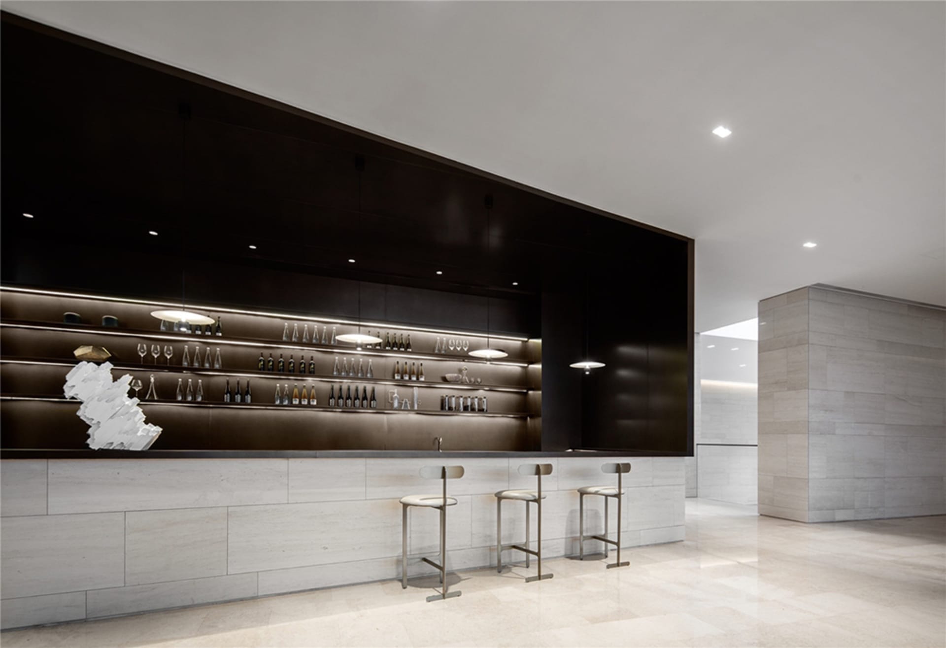 Modern bar counter with concrete finish, showcasing sleek, minimalist design.