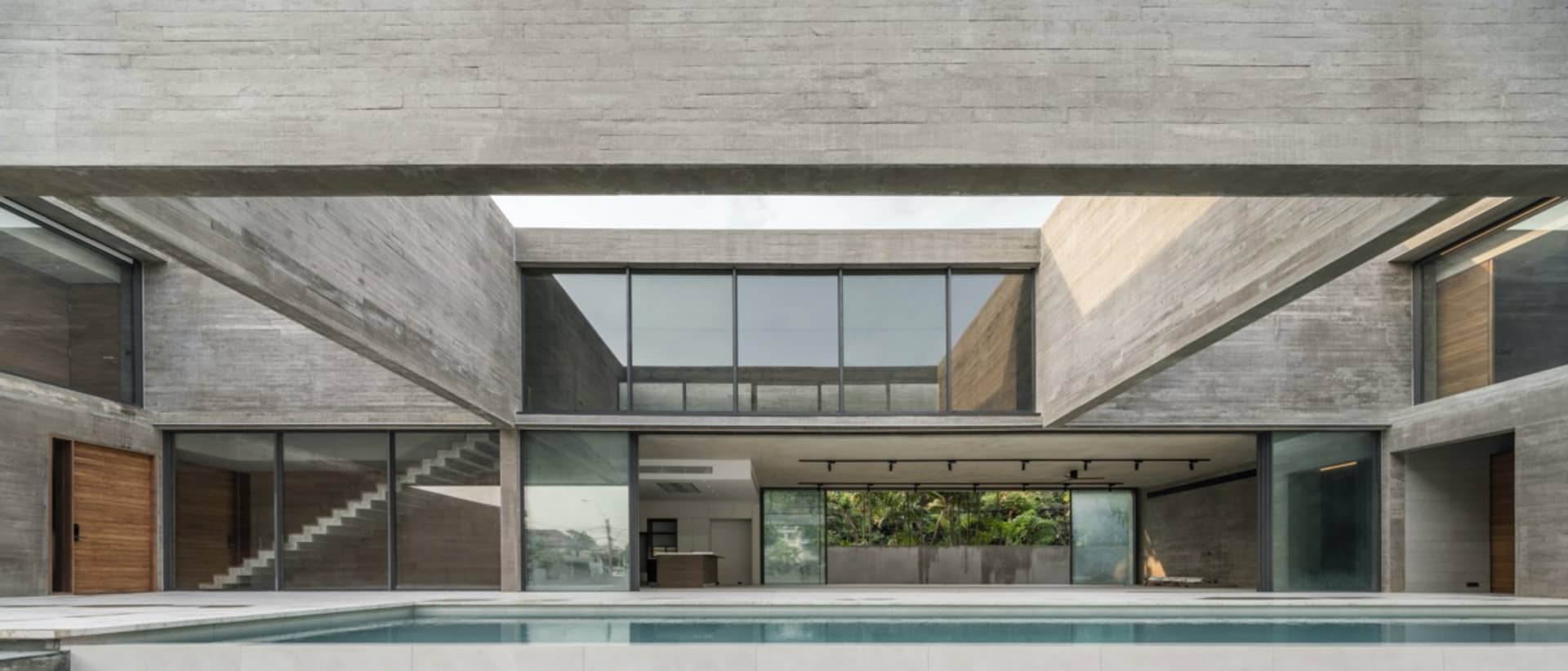 Modern house exterior with a concrete facade and a pool.