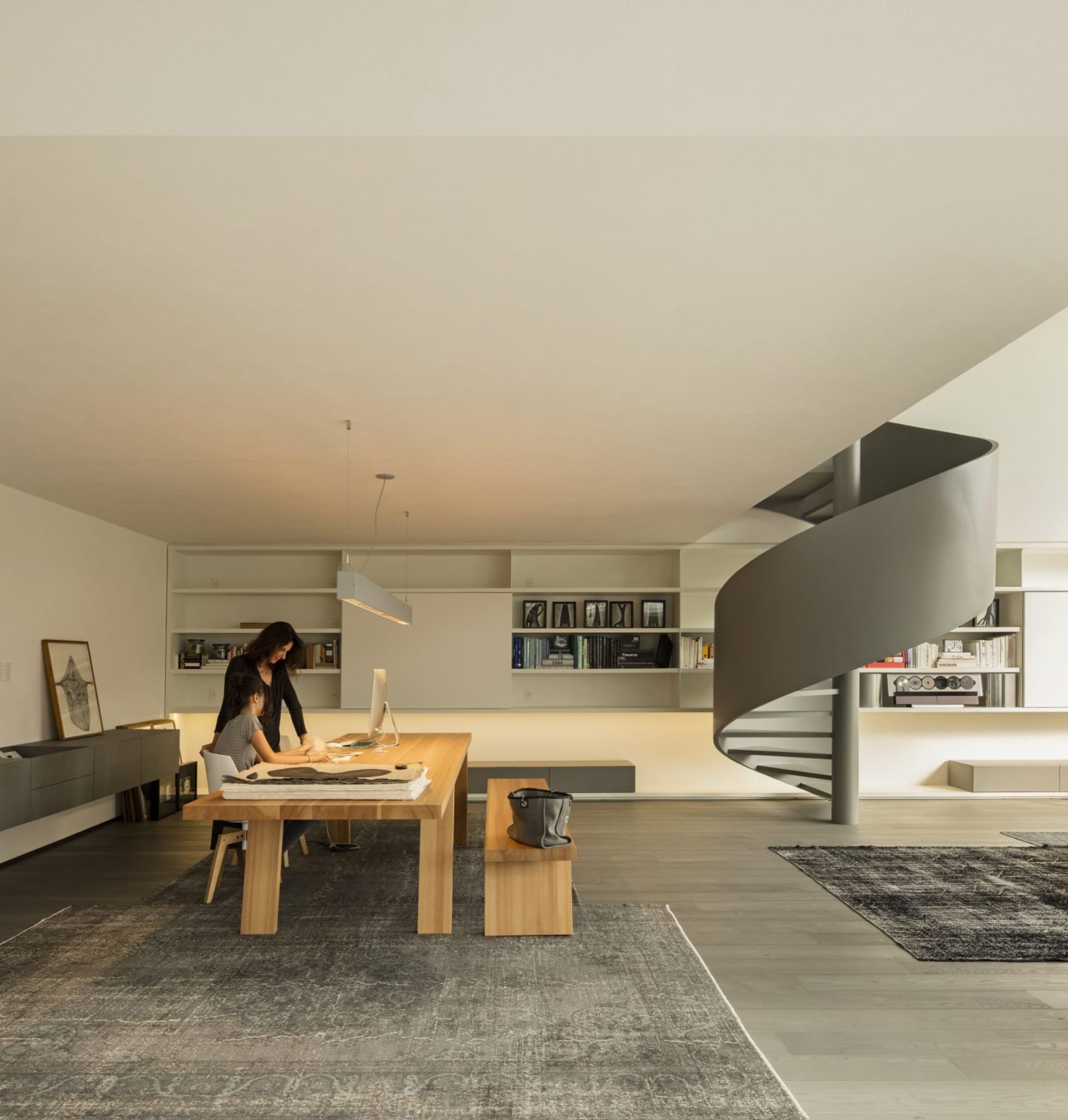 A minimalist office space featuring wooden furniture, designed for functionality and aesthetic simplicity.