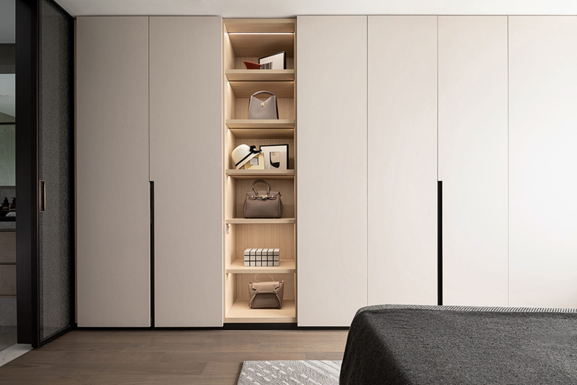 Modern minimalist closet storage system with light wood shelving and steel accents.
