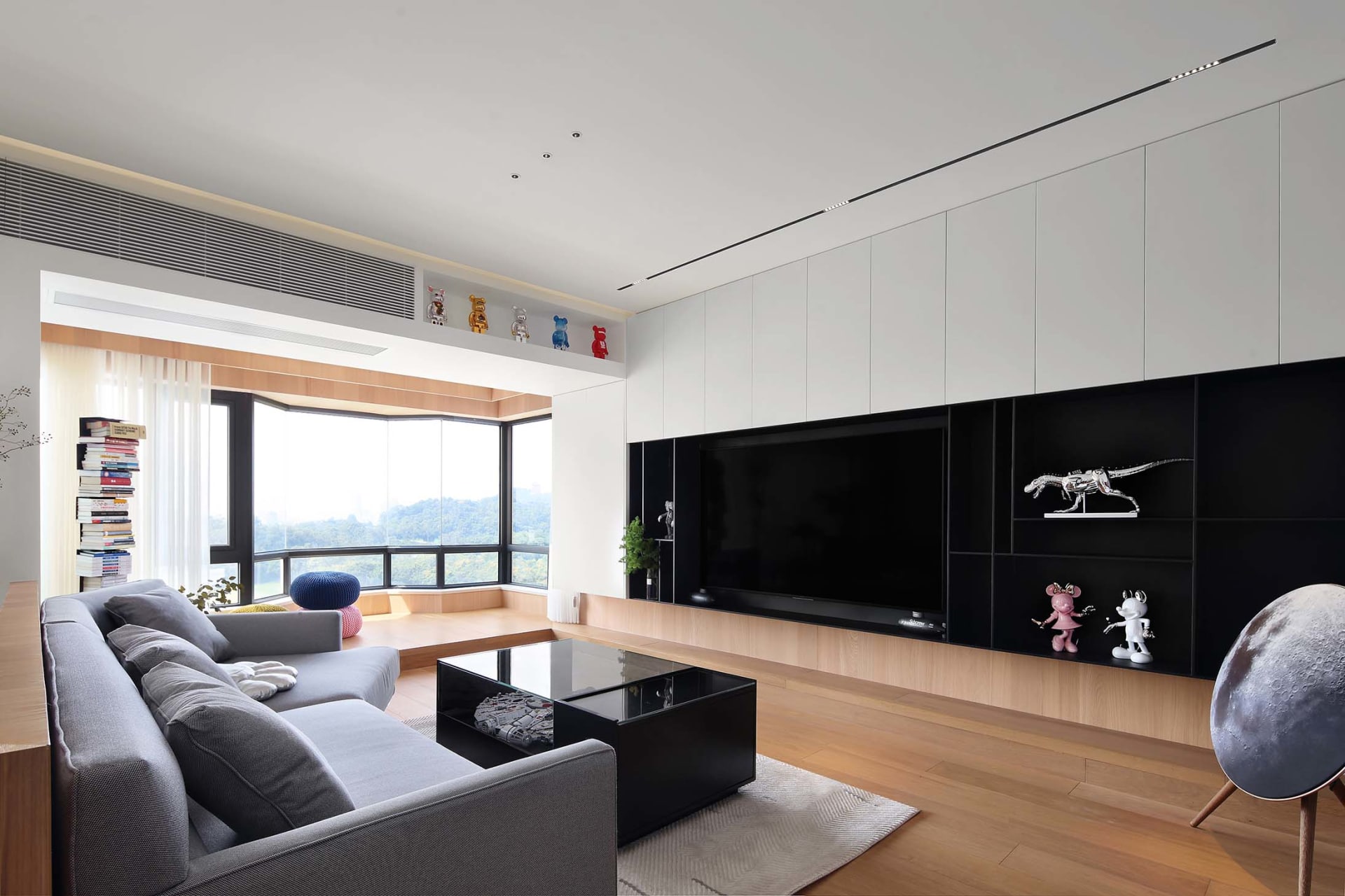 Modern living room with a wooden sofa, coffee table, and decorative items.