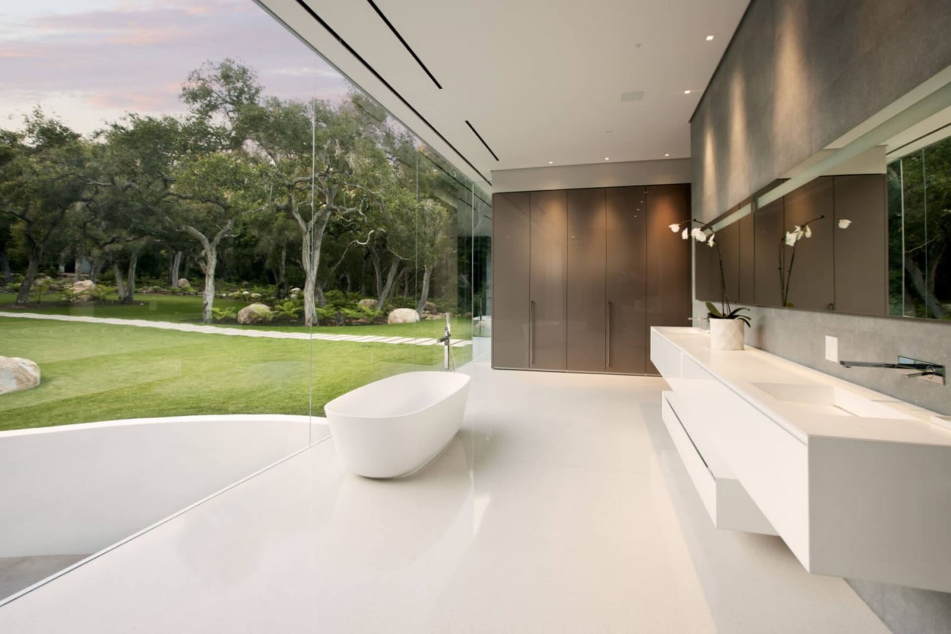Modern minimalist bathroom with white concrete and glass