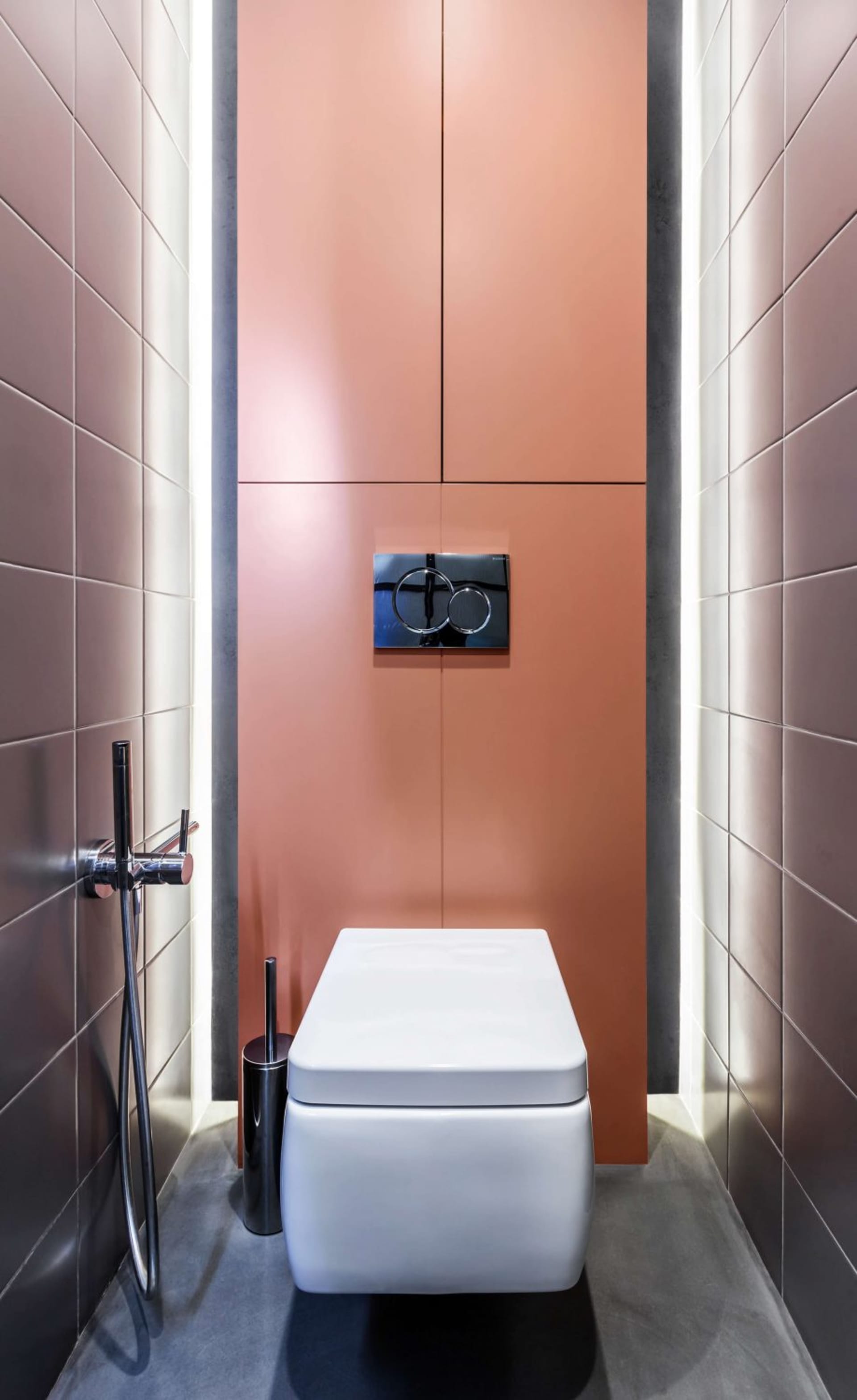 A modern bathroom with white ceramic tiles and a sleek, minimalist design.