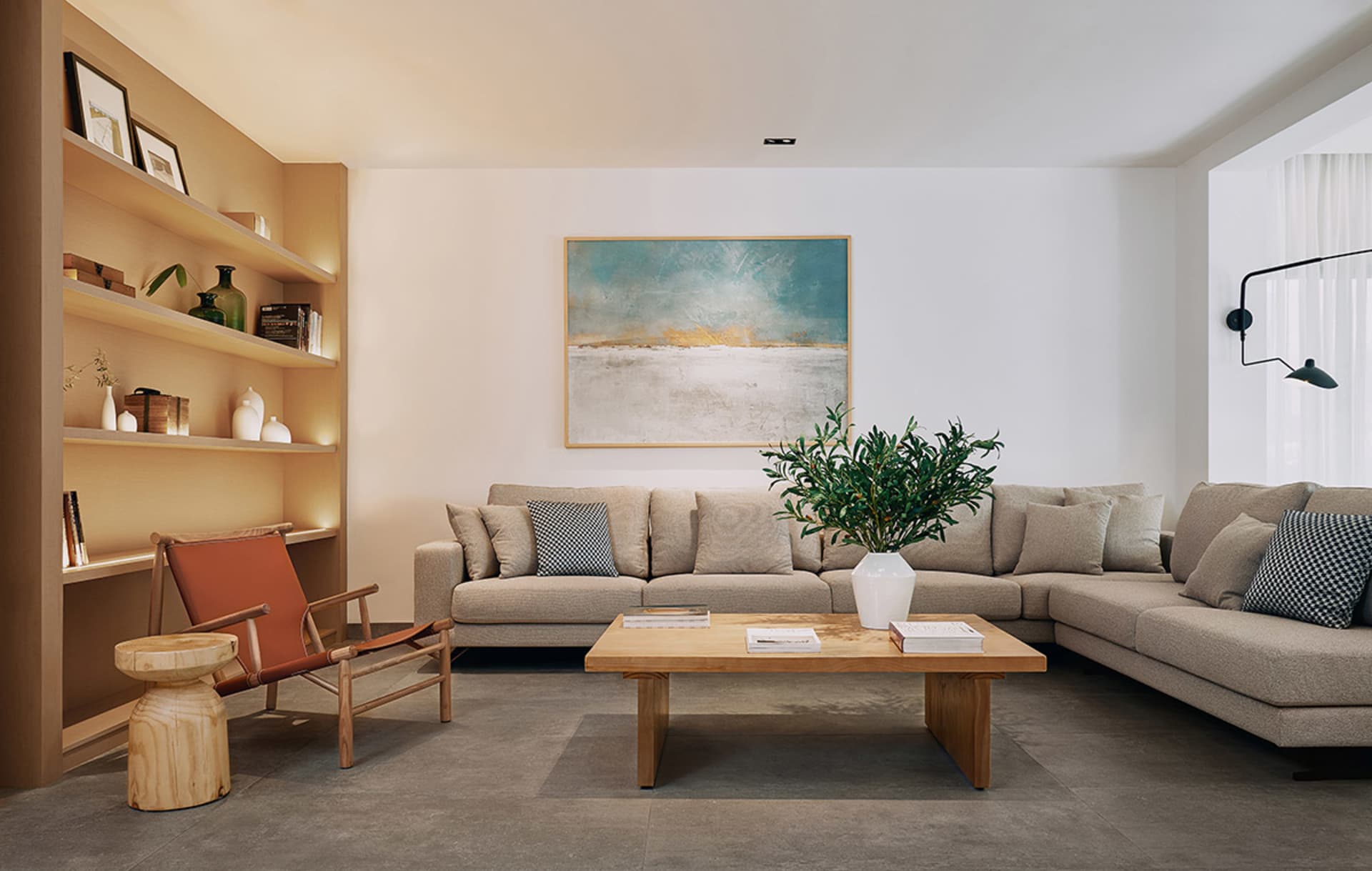 Modern living room featuring minimalist interior design with neutral-colored furnishings and a large abstract painting on the