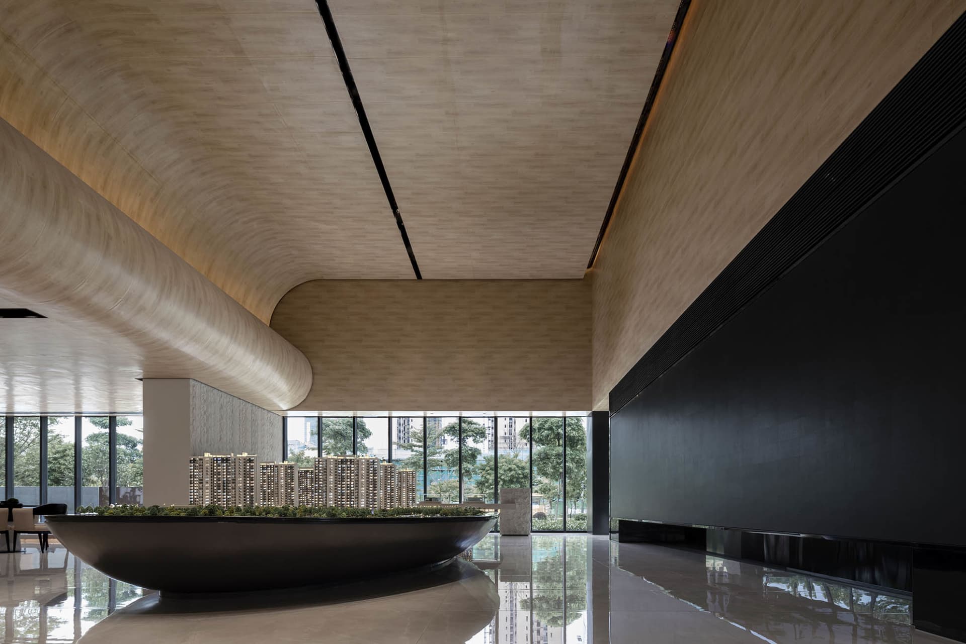 Modern lobby with concrete and glass walls and a wooden ceiling