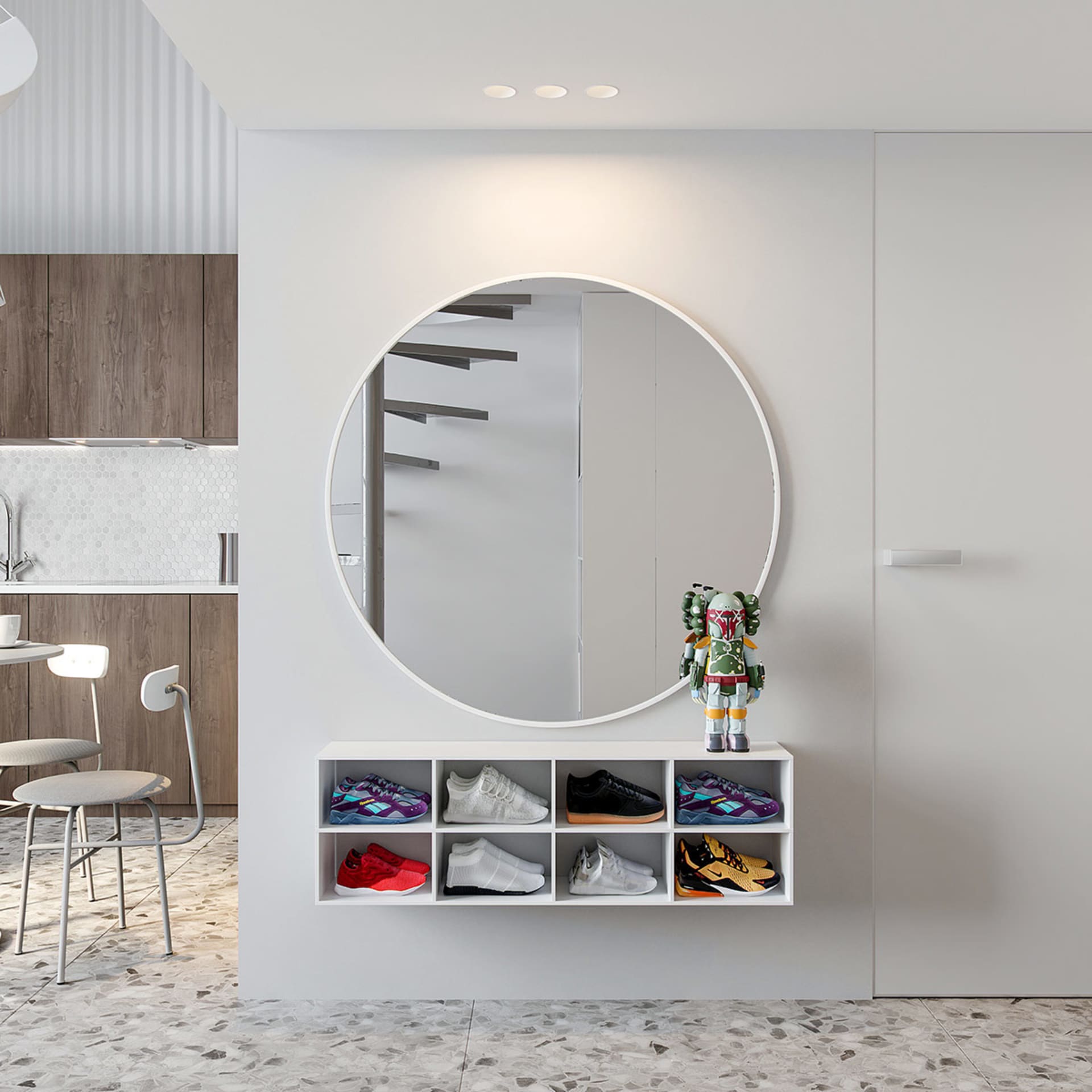 A modern minimalist entryway with a round mirror, shoe shelves, and a terrazzo floor.