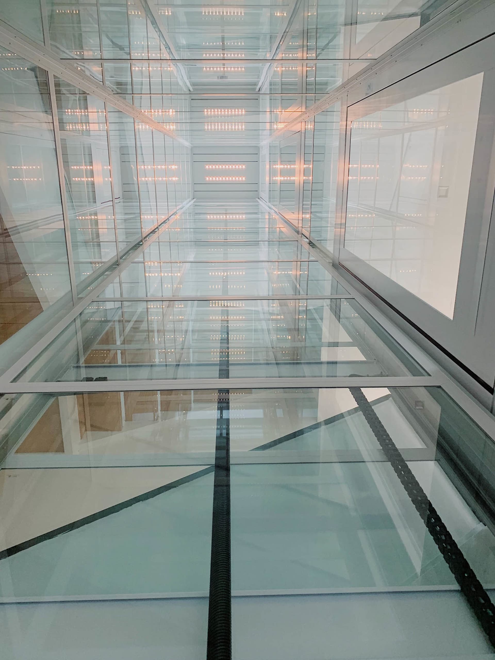 A modern interior space with glass walls and a sleek design.