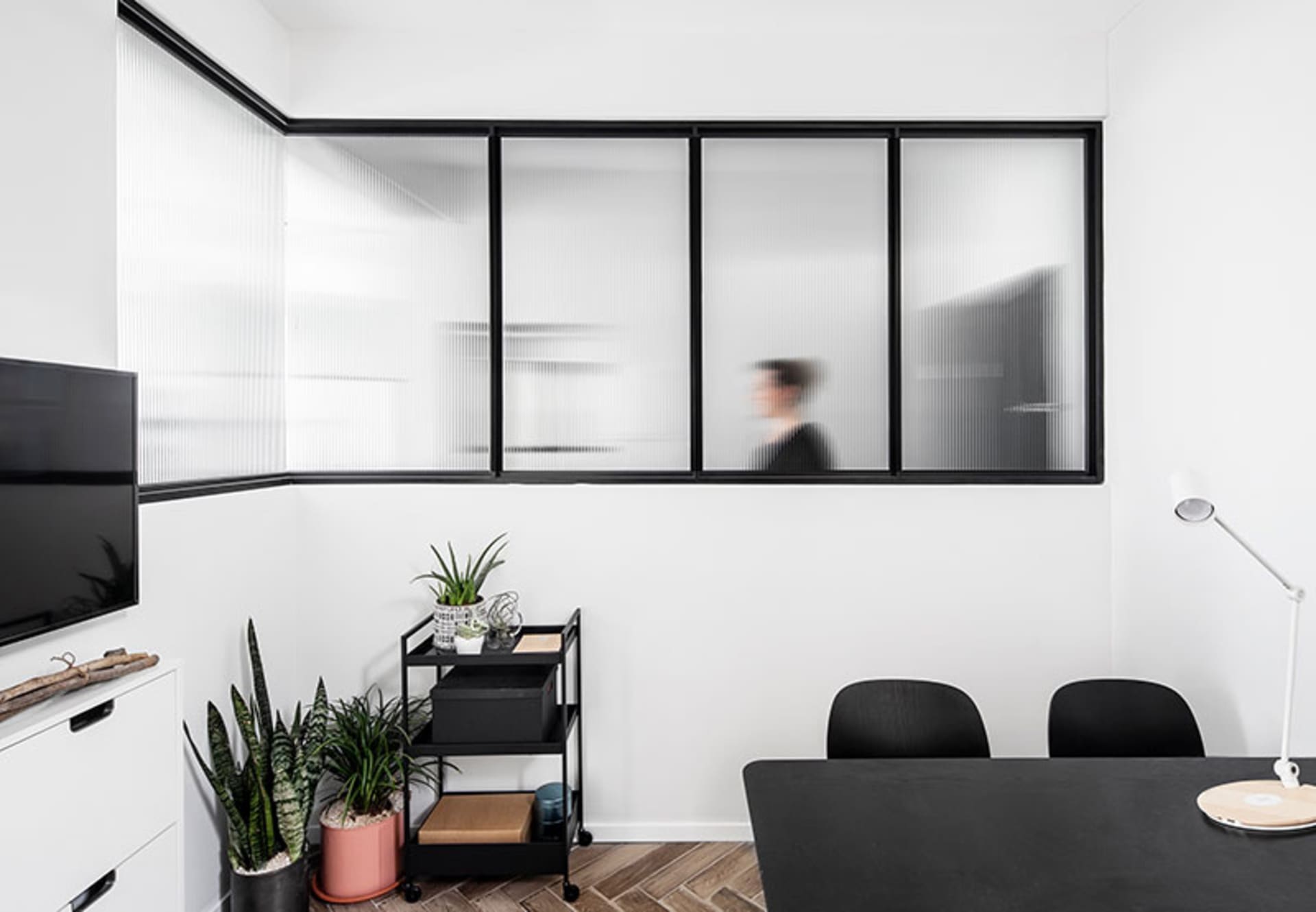 A modern office space featuring mixed materials and a minimalist design.
