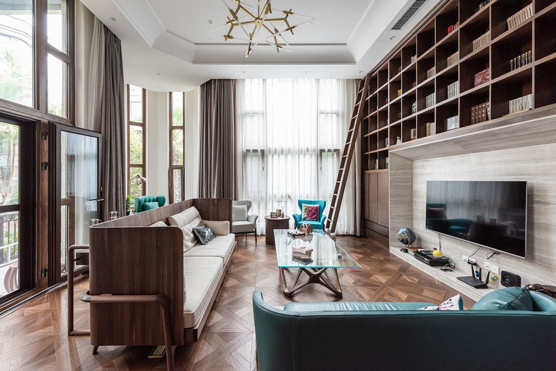 A modern living room featuring wooden furniture and a large bookshelf.