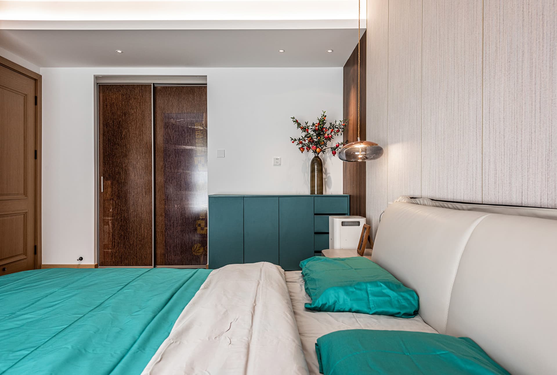 A modern bedroom featuring a fabric bed with wood and metal accents.
