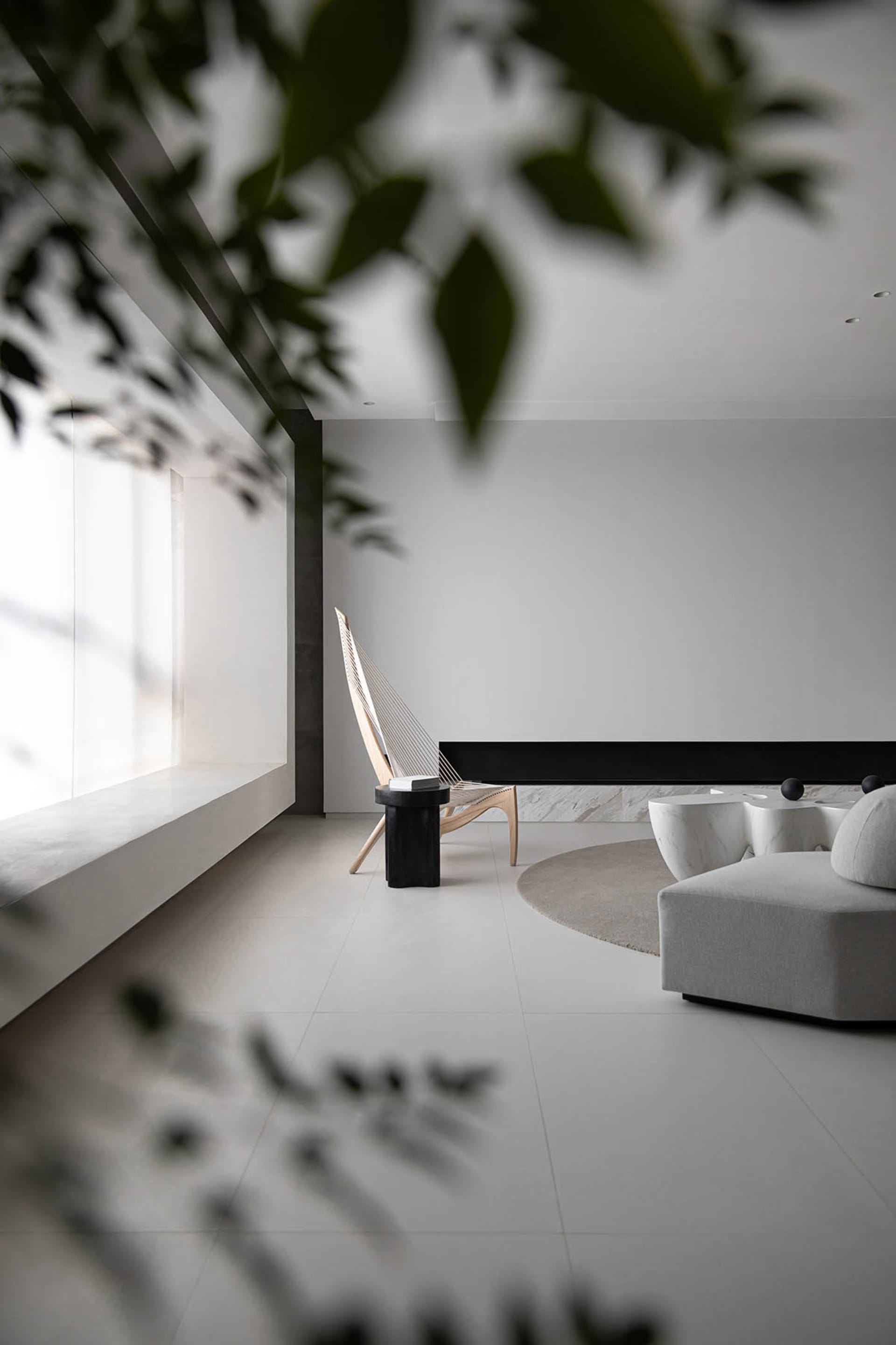 Modern minimalist living room featuring minimalist furniture and concrete floor.