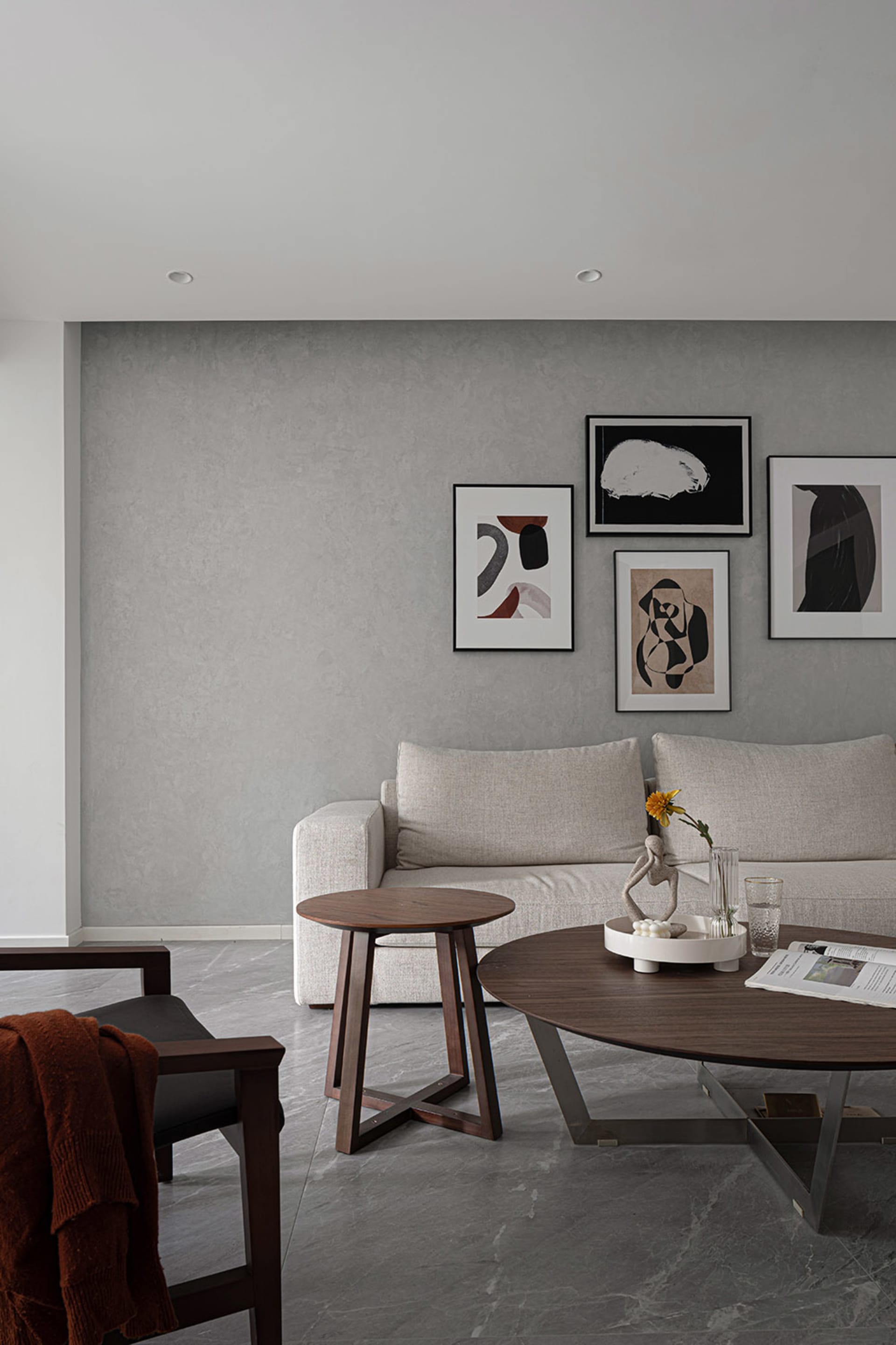 A modern minimalist living room featuring fabric furniture, wood and metal accents, and a cozy atmosphere.