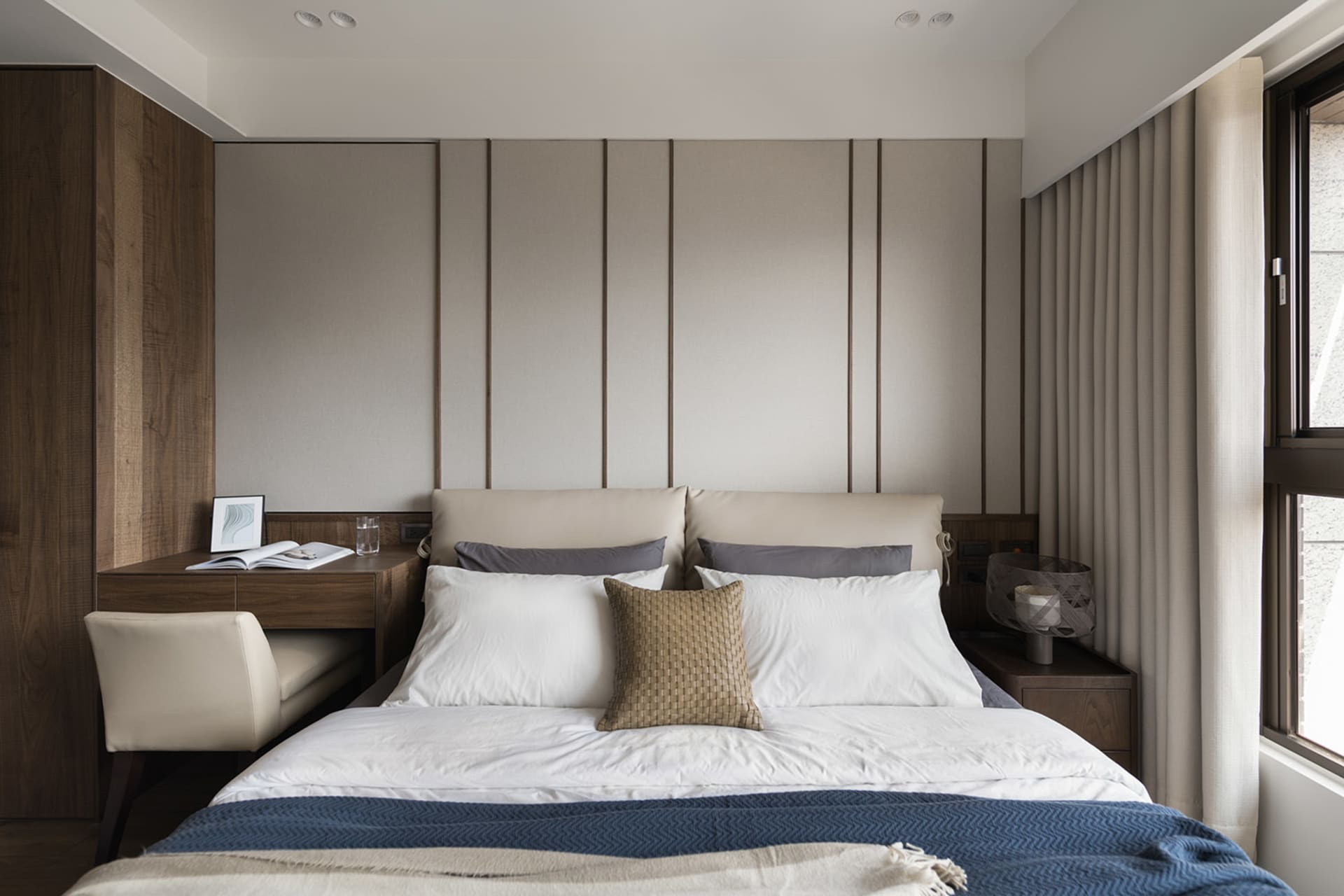 Modern bedroom featuring fabric, wood, and metal elements.
