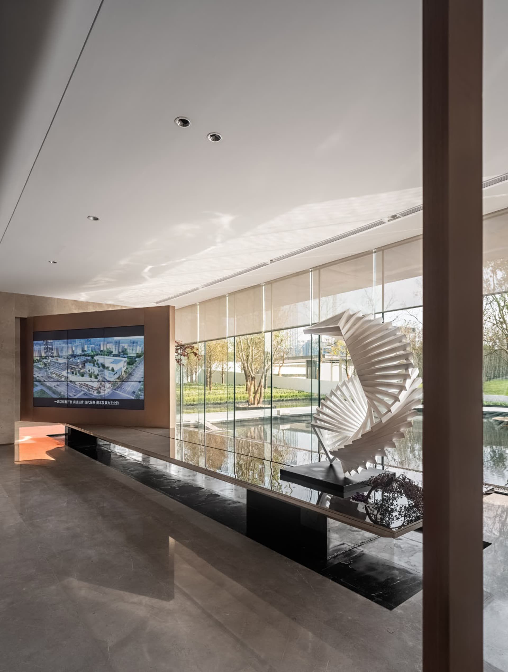 A modern lobby featuring glass, steel, and marble materials.