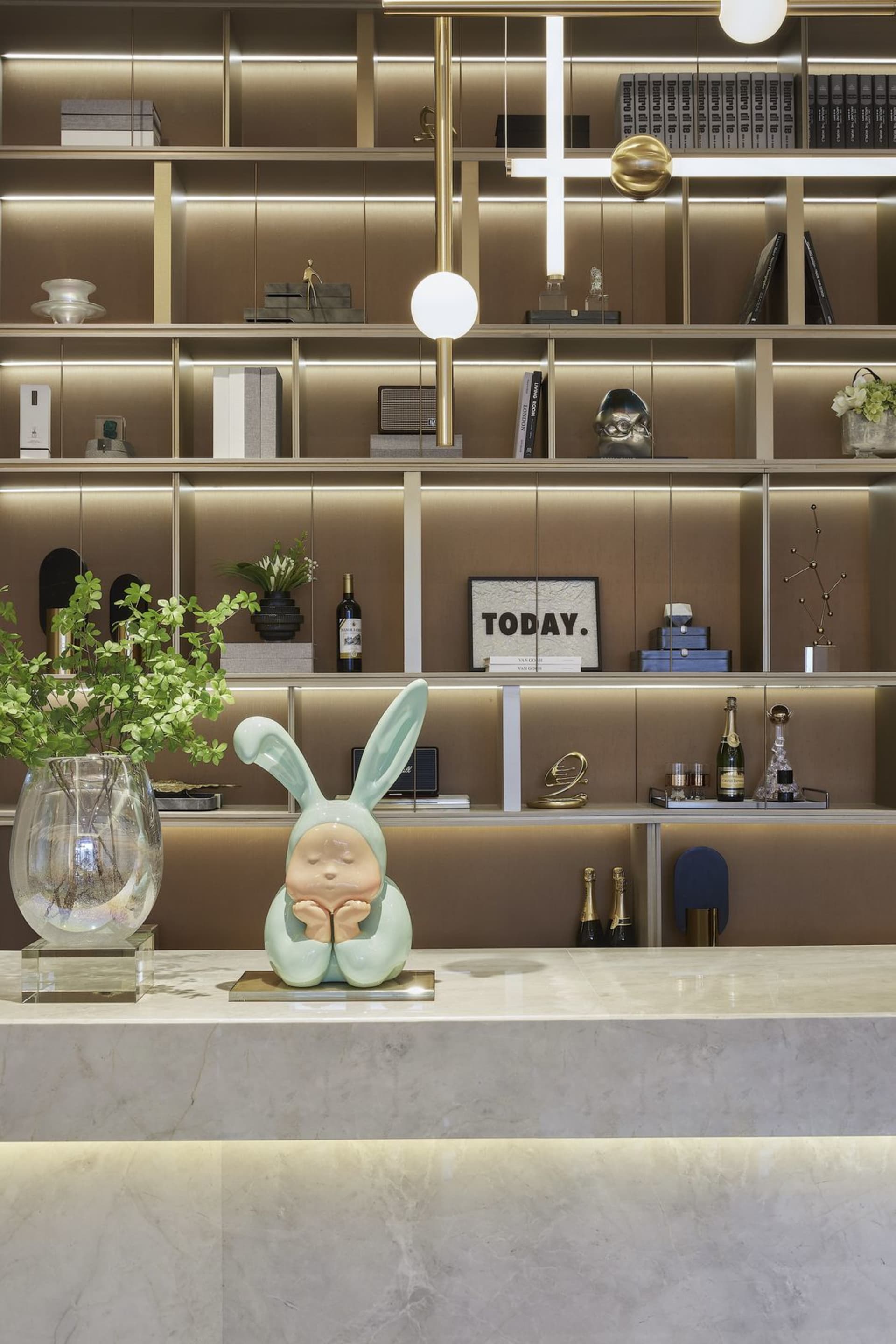 A modern reception desk made of marble with a rabbit figurine on top and decorative items arranged on the shelves in the back