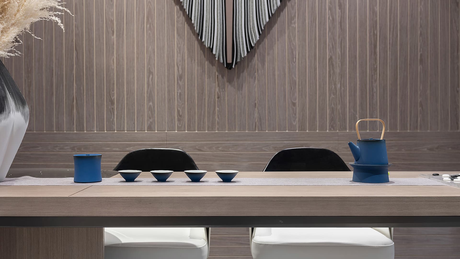 A sleek, minimalist tea ceremony space featuring wooden materials and contemporary blue accents.
