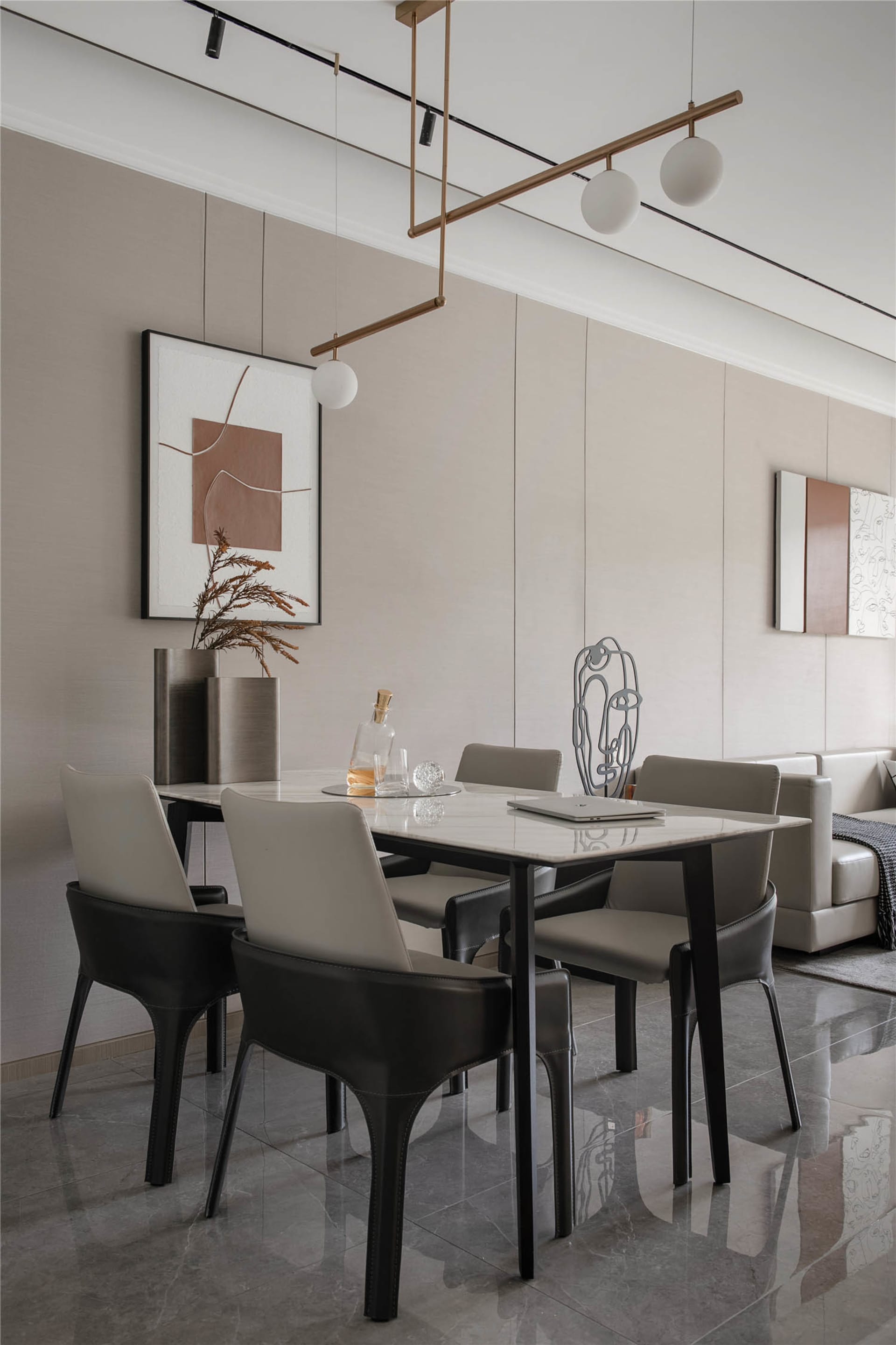 Modern dining room with marble table and black leather chairs