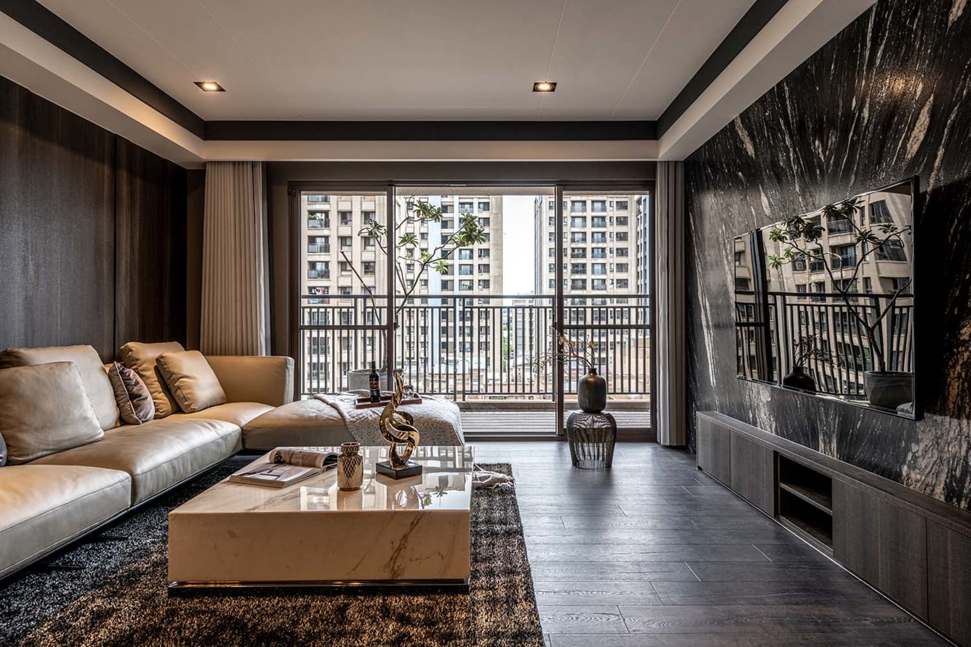 Modern living room with marble coffee table, leather sofa, and metal accents