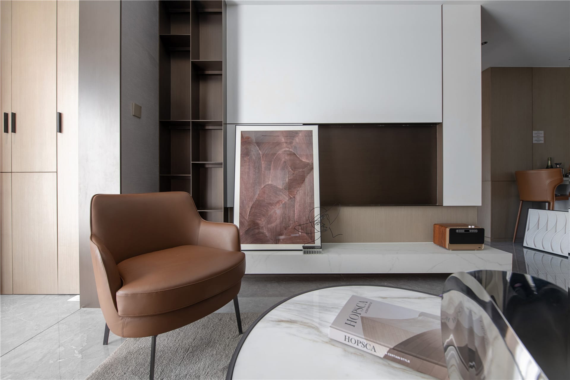 A modern living room featuring contemporary furniture, a minimalist design, and a sleek, white coffee table.
