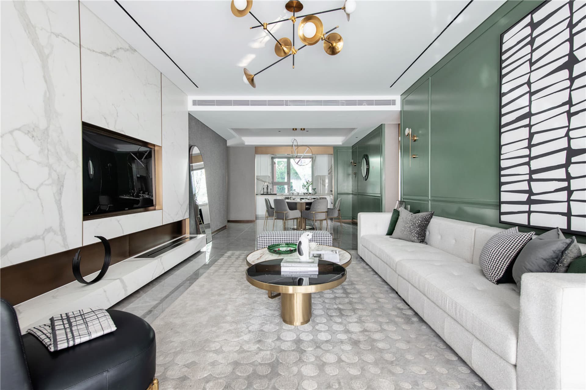 A modern minimalist living room with a marble fireplace, a textured white sofa, and a metal coffee table.