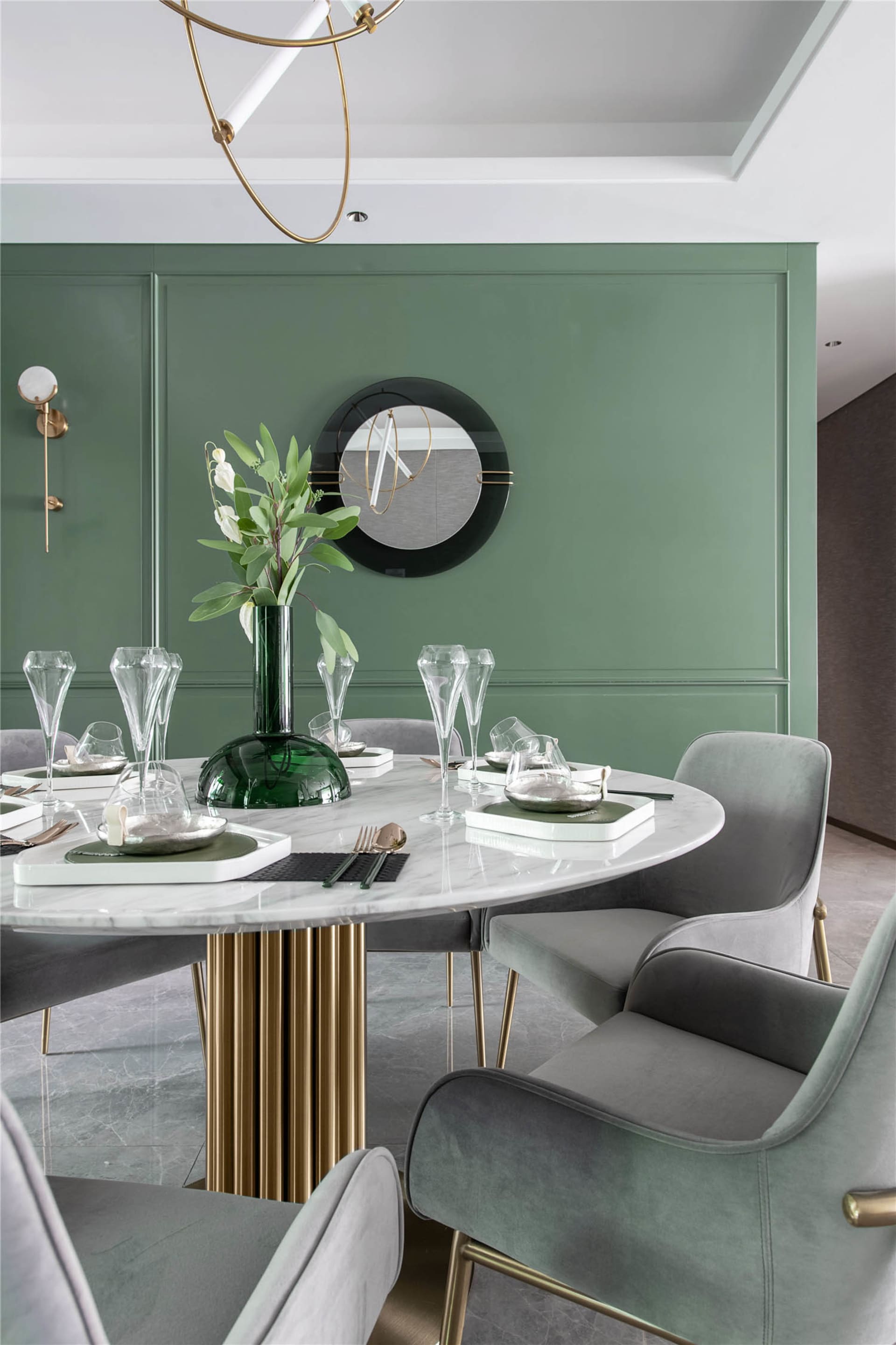 A modern dining room featuring a white marble table with green accents, surrounded by velvet upholstered chairs, and a geomet