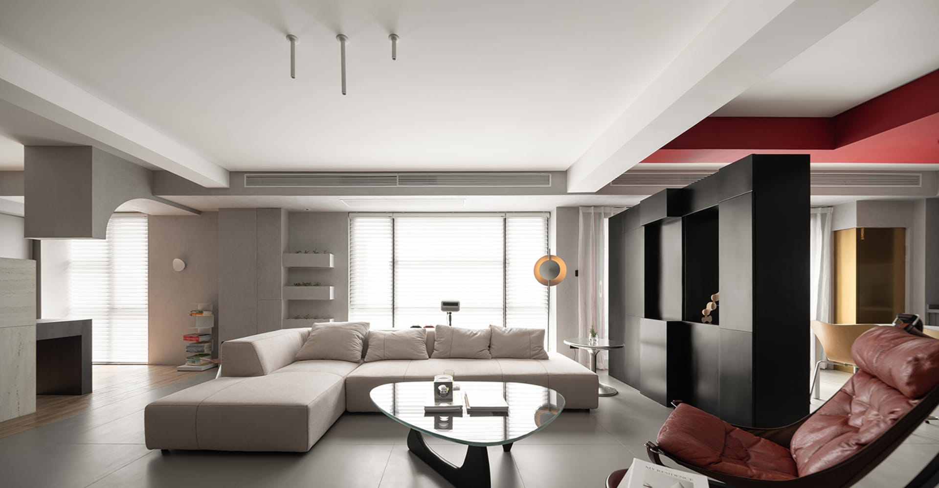 Modern minimalist residential interior with concrete walls, glass windows, and stylish furniture.