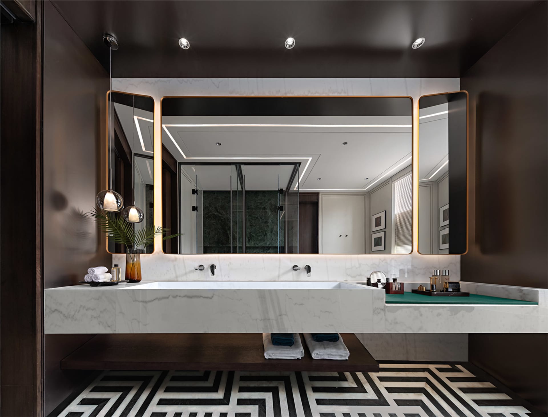 A modern bathroom interior featuring marble fixtures and geometric flooring patterns.